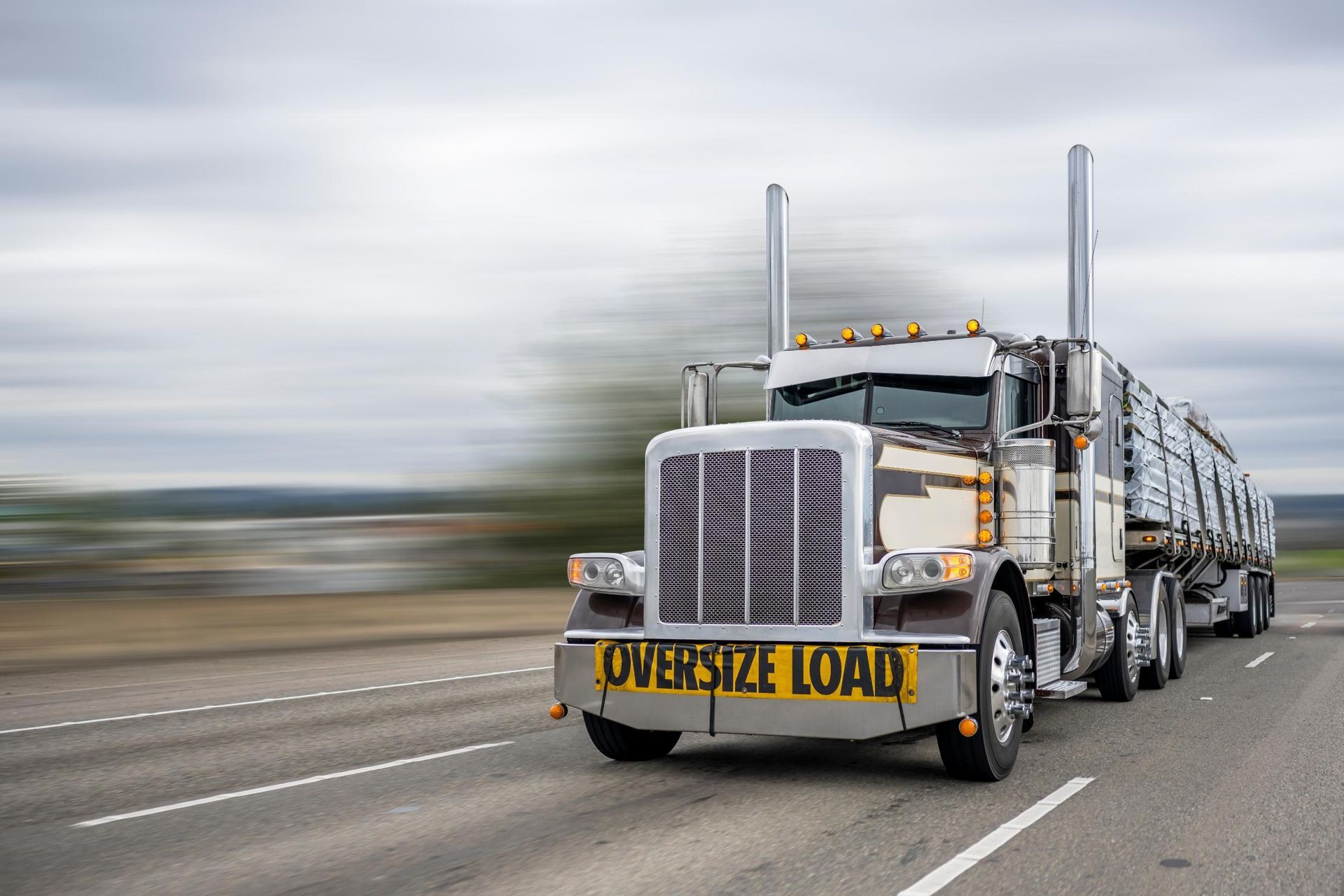 A large semi truck is driving down a highway.