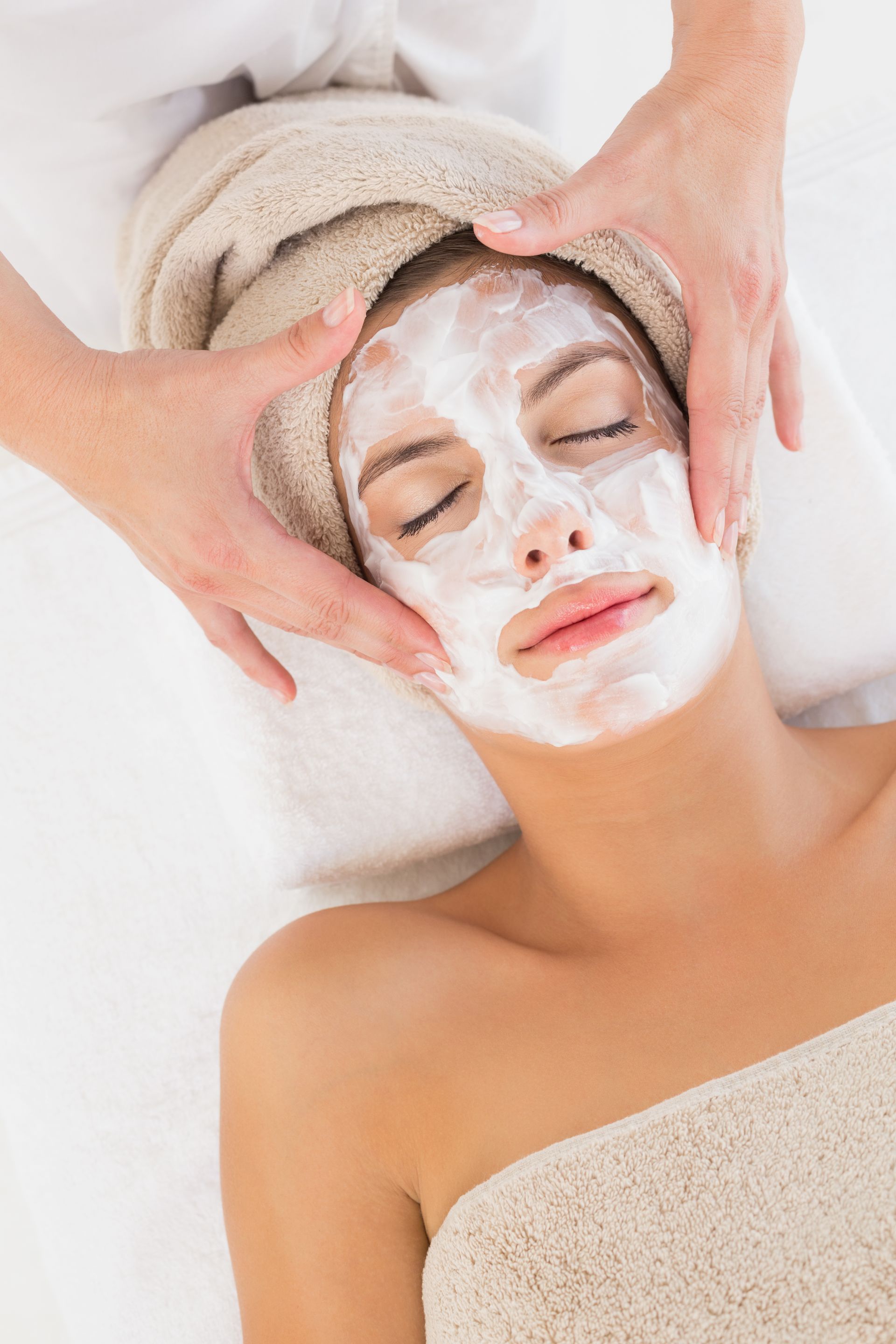 A woman is getting a facial treatment at a spa.