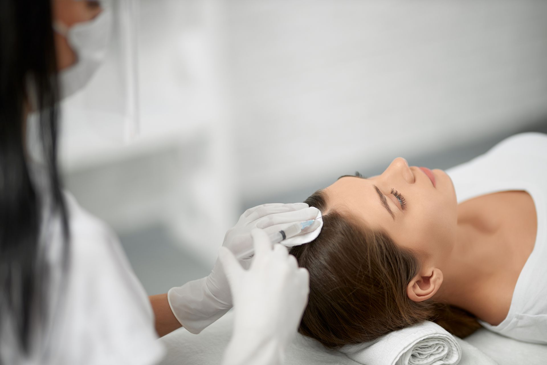 A woman is getting a facial treatment at a beauty salon.