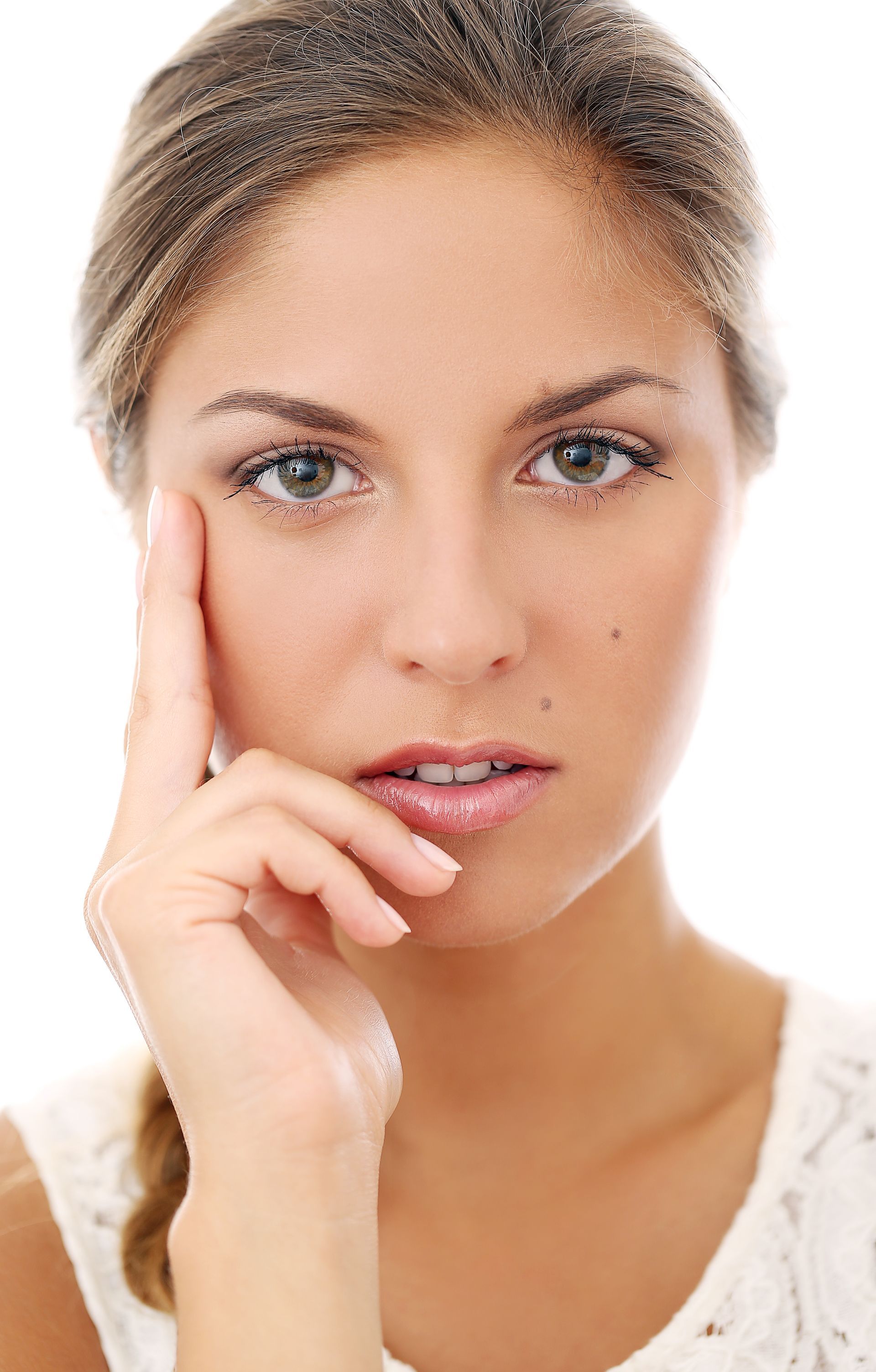 A close up of a woman 's face with her hand on her chin