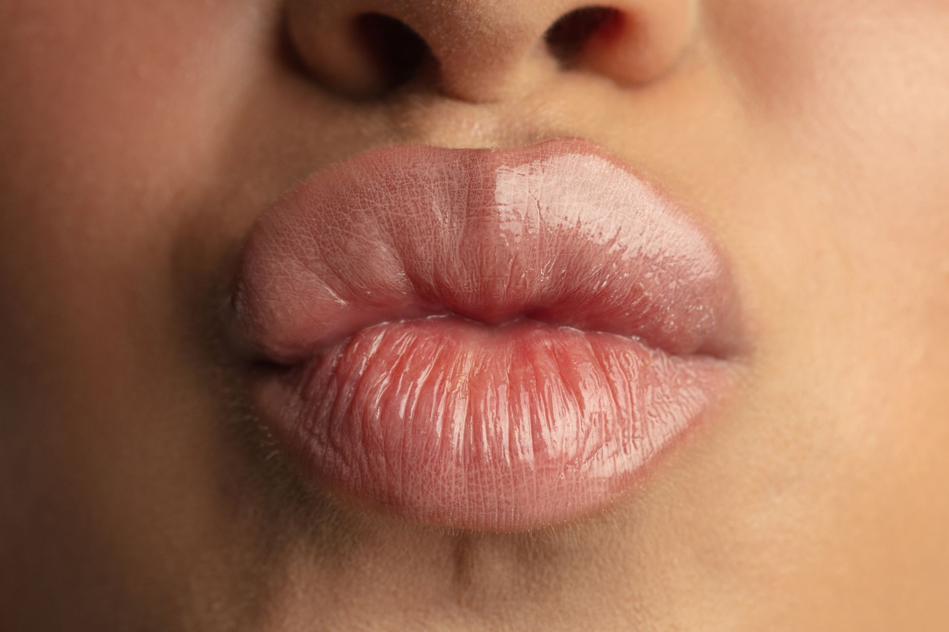 a close up of a woman 's lips blowing a kiss .