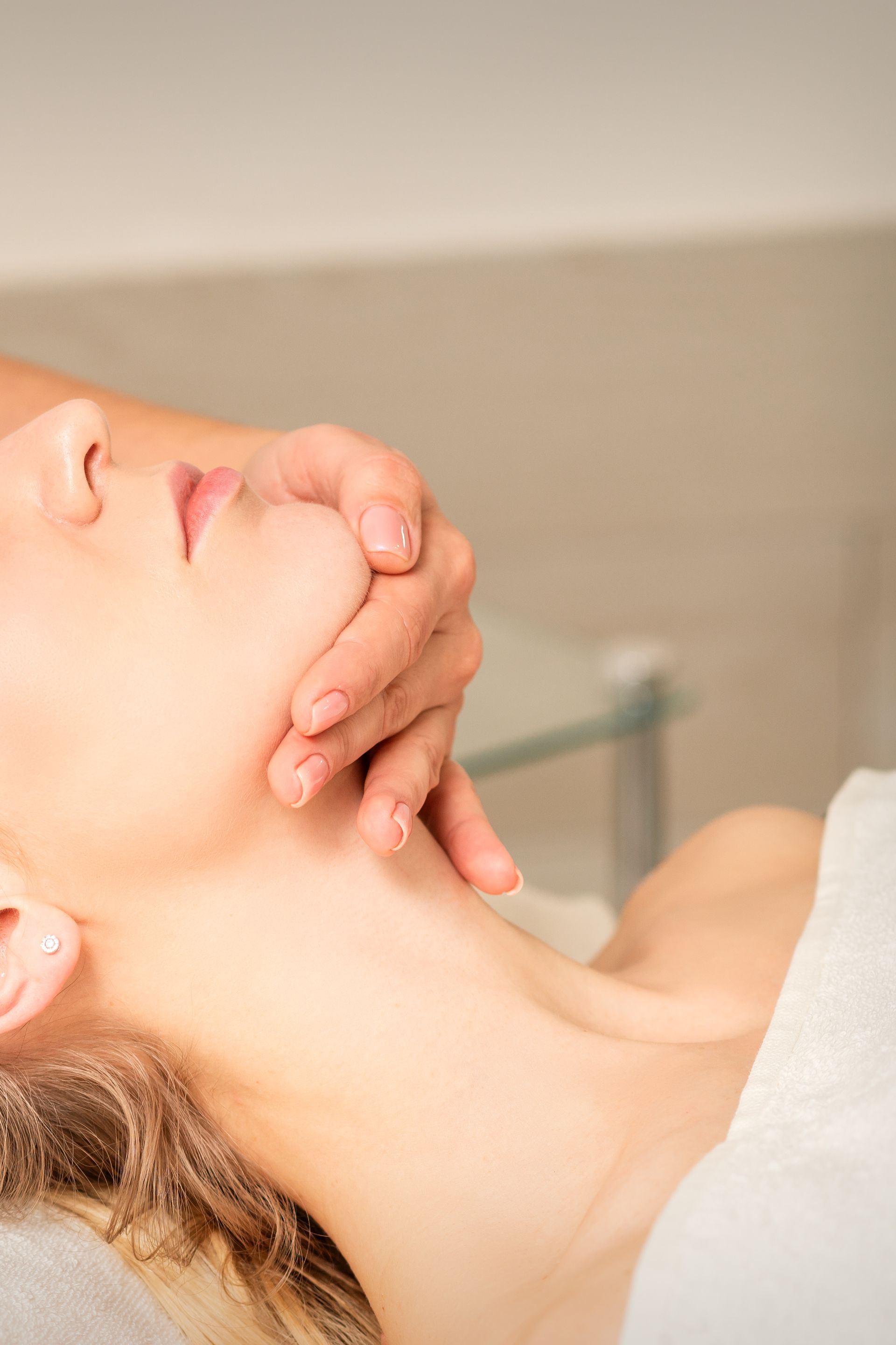 a woman is getting a neck massage at a spa .