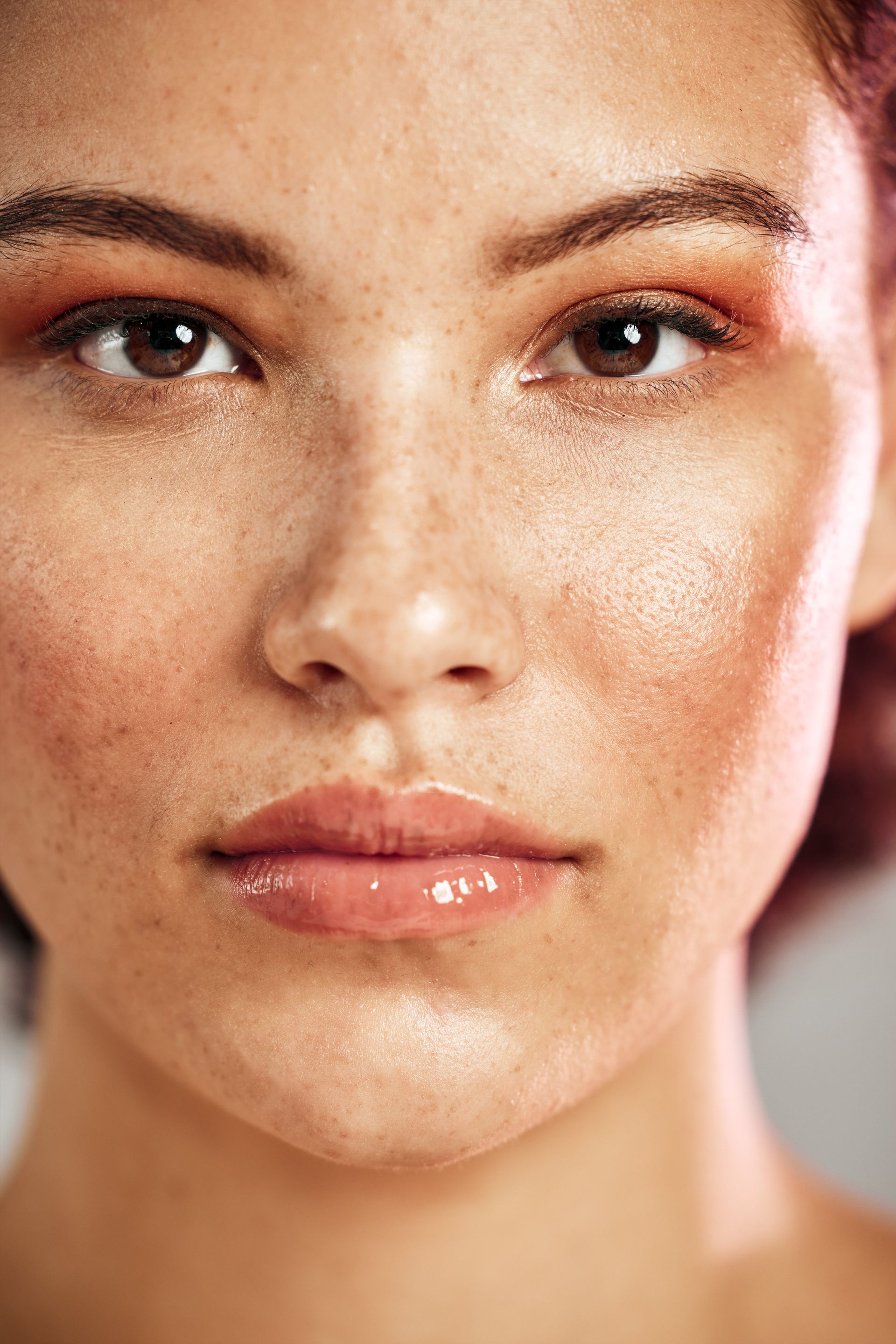 A close up of a woman 's face with makeup on.