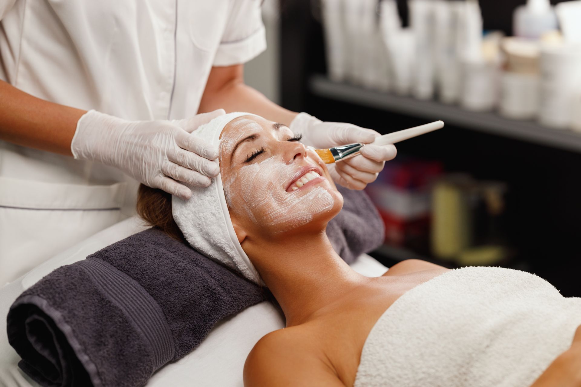 A woman is getting a facial treatment at a spa.