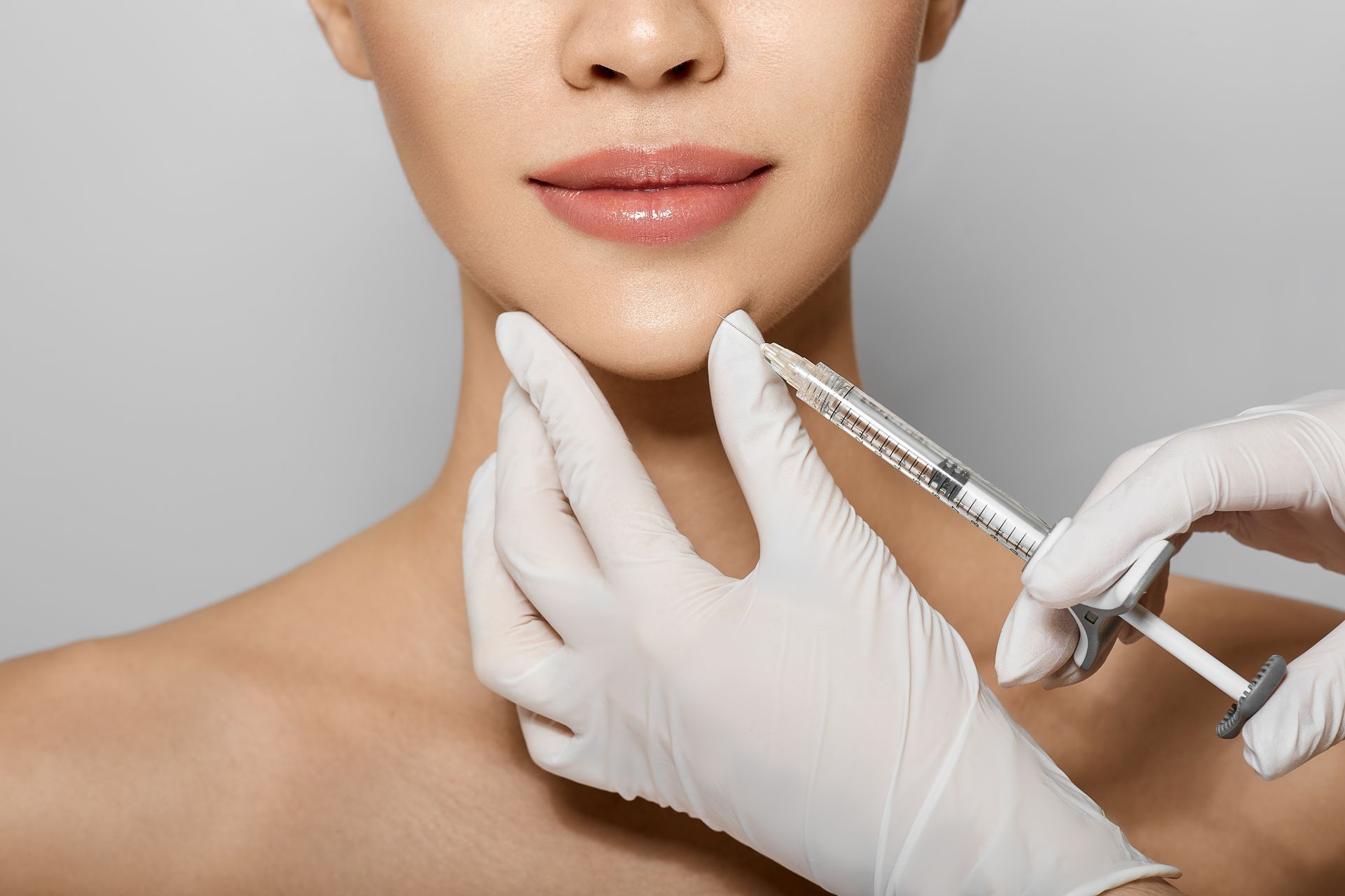 a woman is getting a botox injection in her neck .