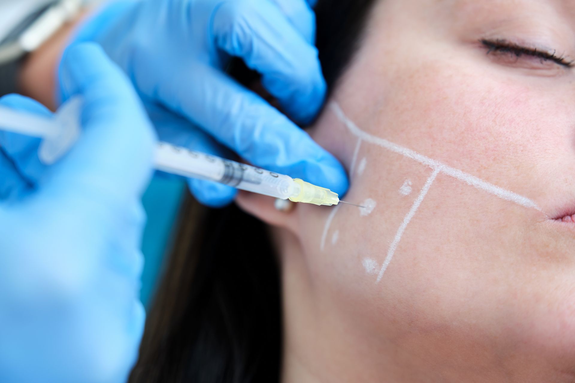 a woman is getting a botox injection in her face .