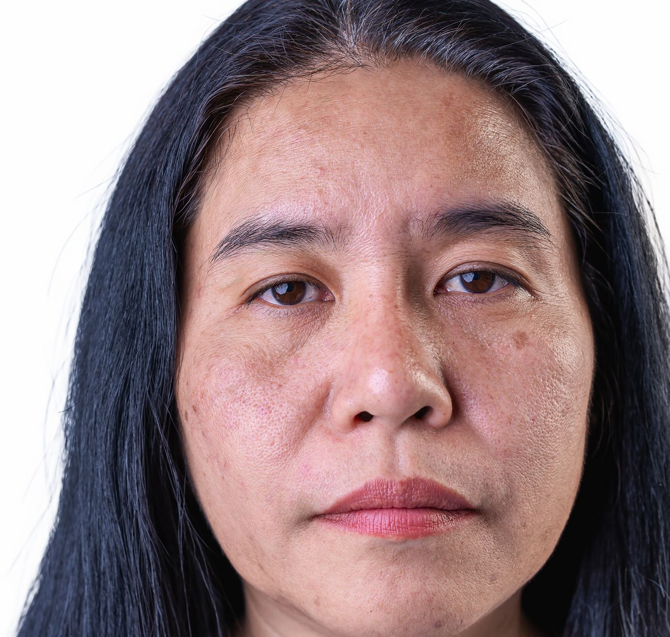 A headshot of a person with dark hair, looking directly at the camera with a neutral expression against a white background.
