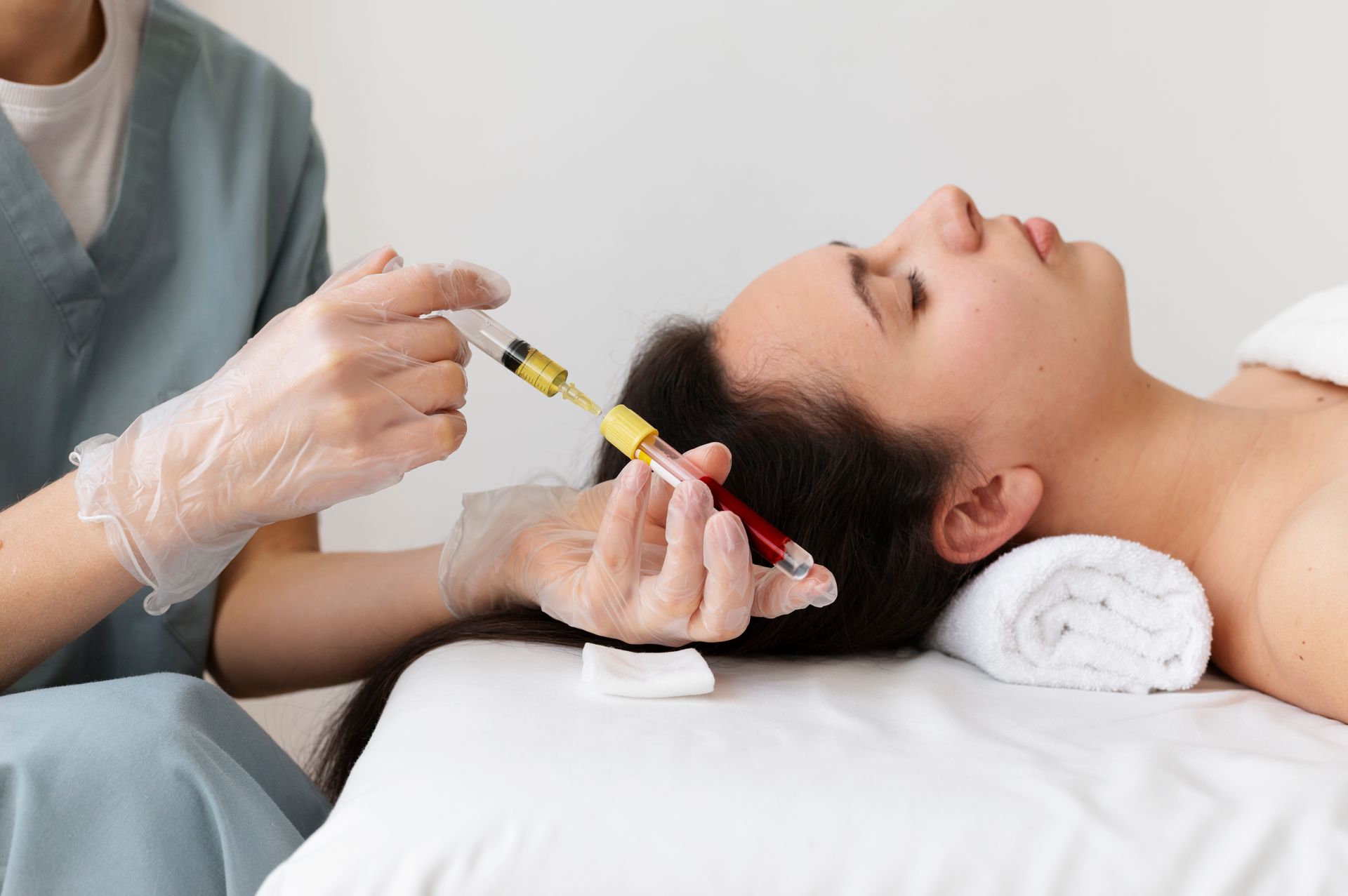 A woman is getting an injection in her hair.