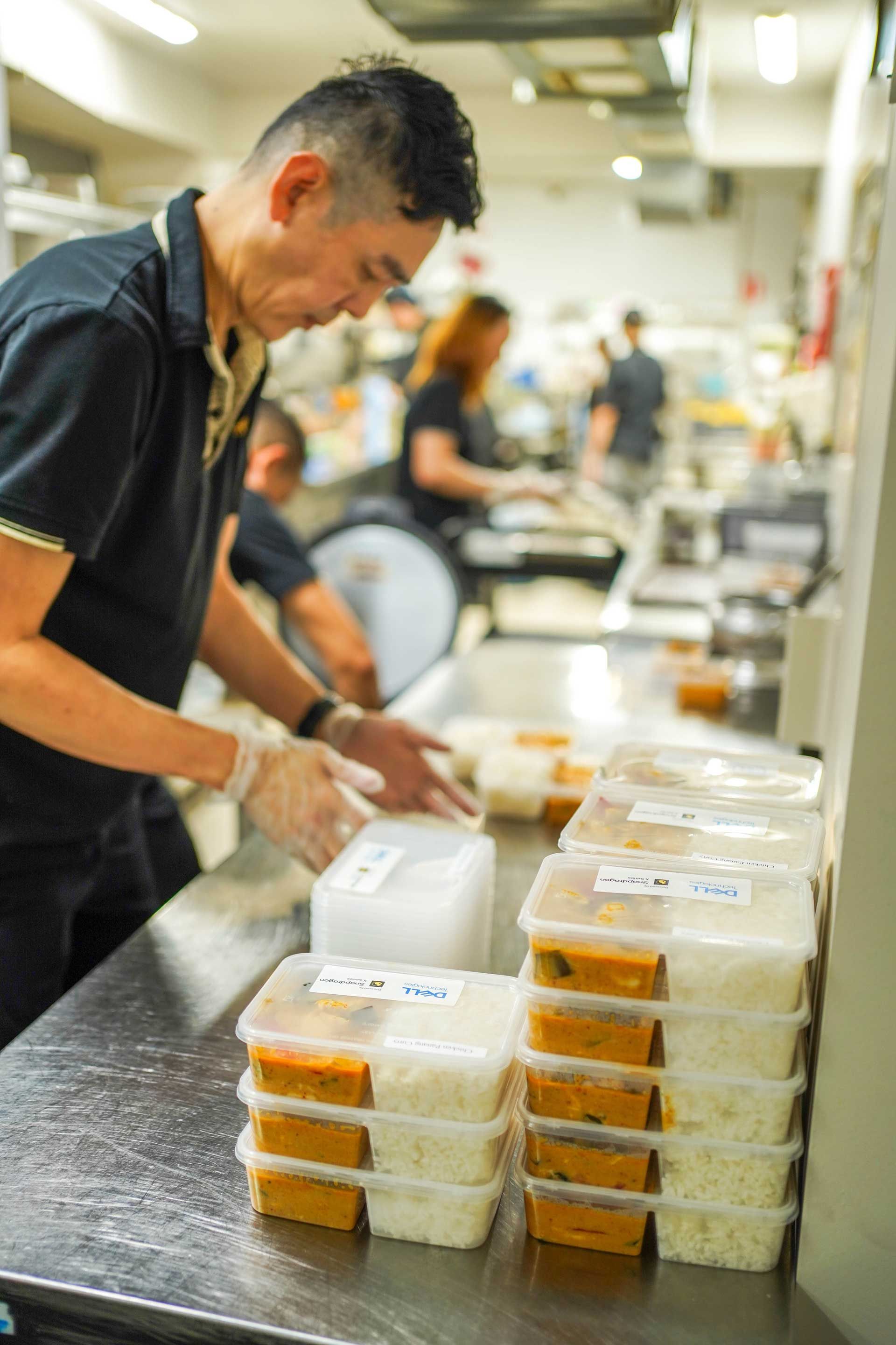 Thai Pothong Staff is preparing Thai food on a counter in a kitchen.