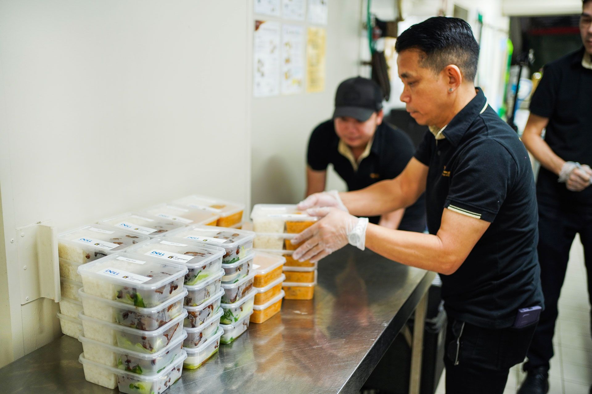A man is preparing food on a counter in a kitchen.