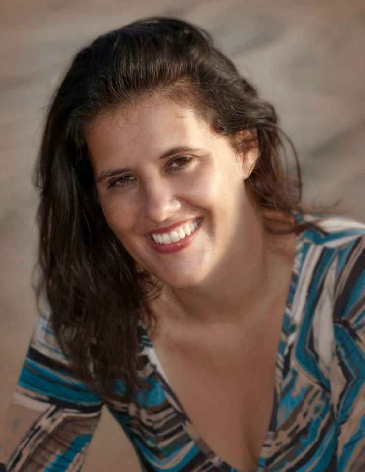 A man in a suit and tie is smiling for the camera.