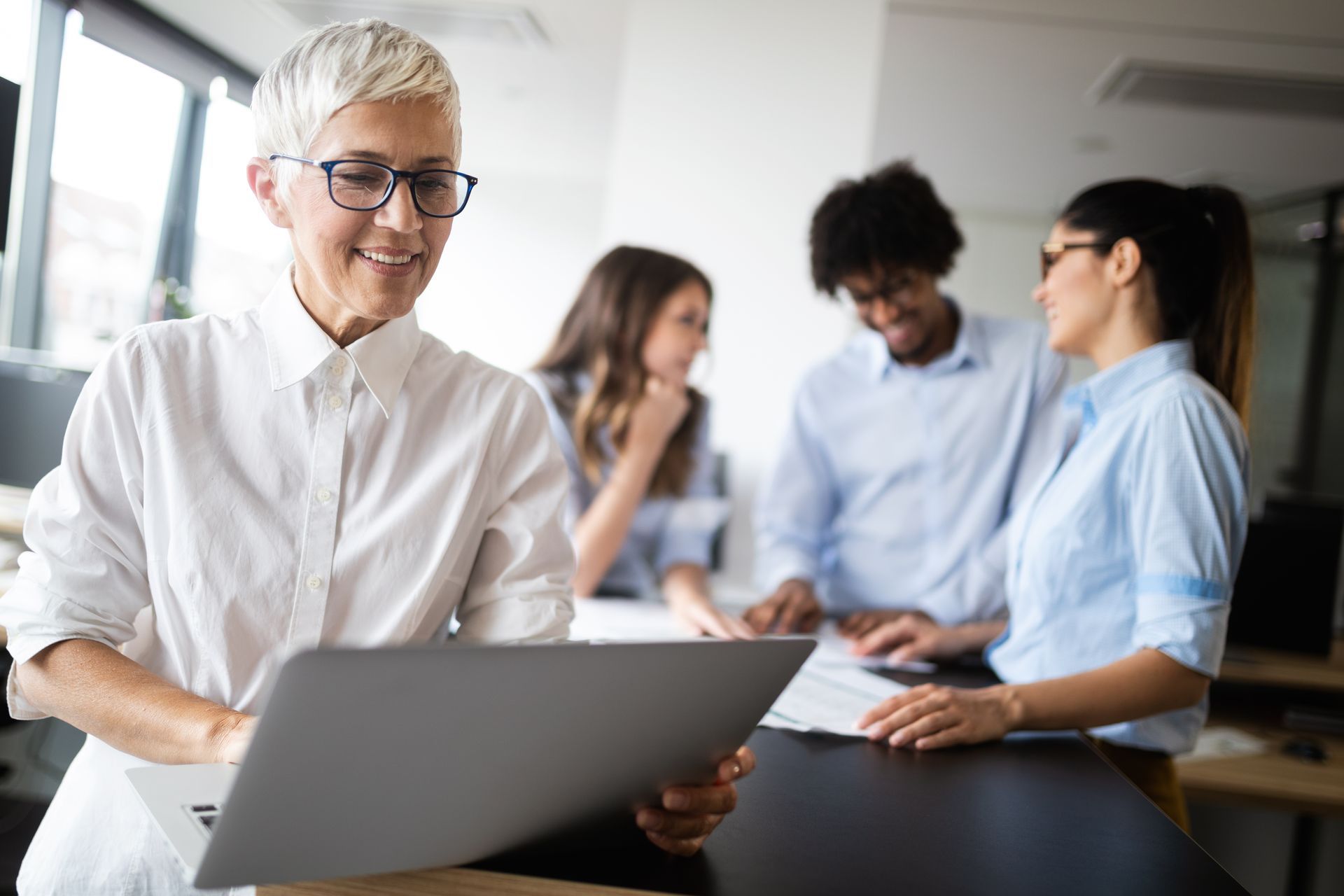 A lake in the middle of a forest with trees in the background