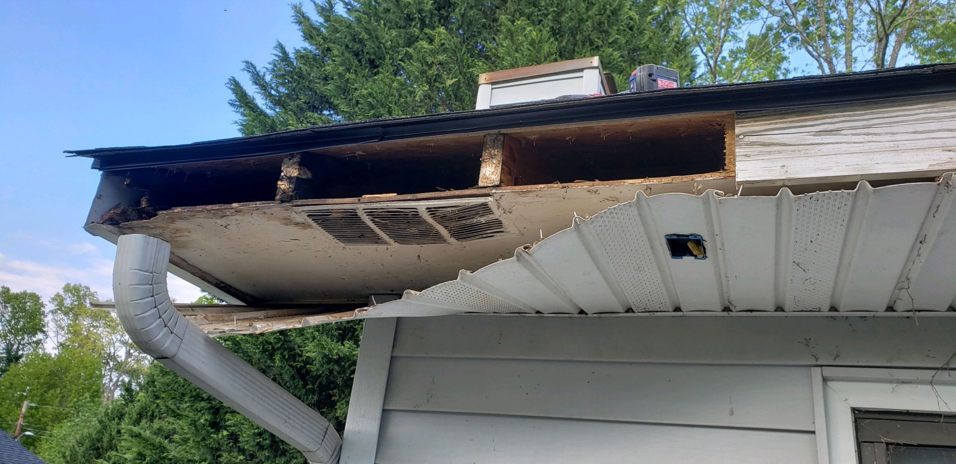 There is a hole in the roof of a house.