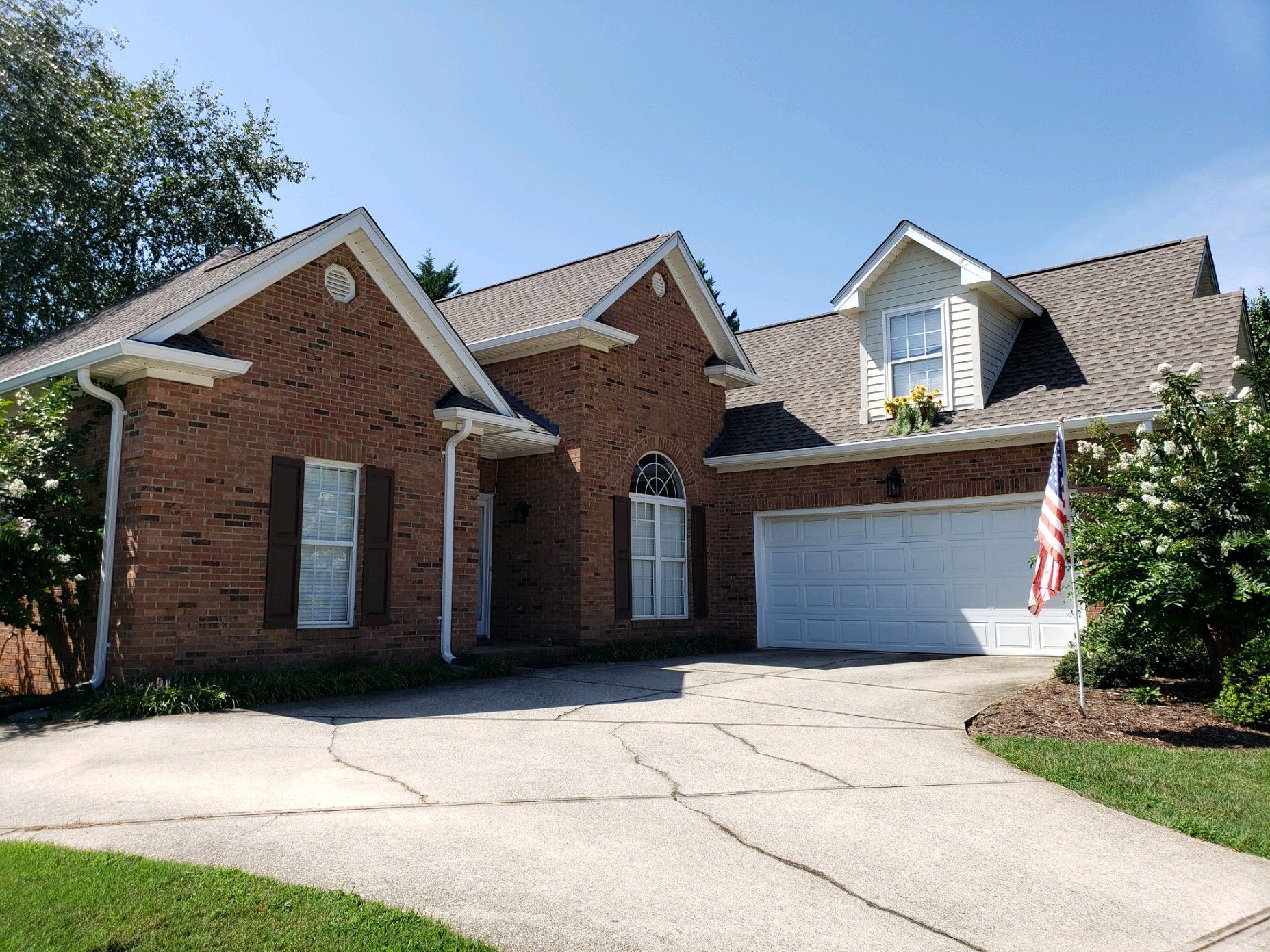 a  large brick house with a white garage door