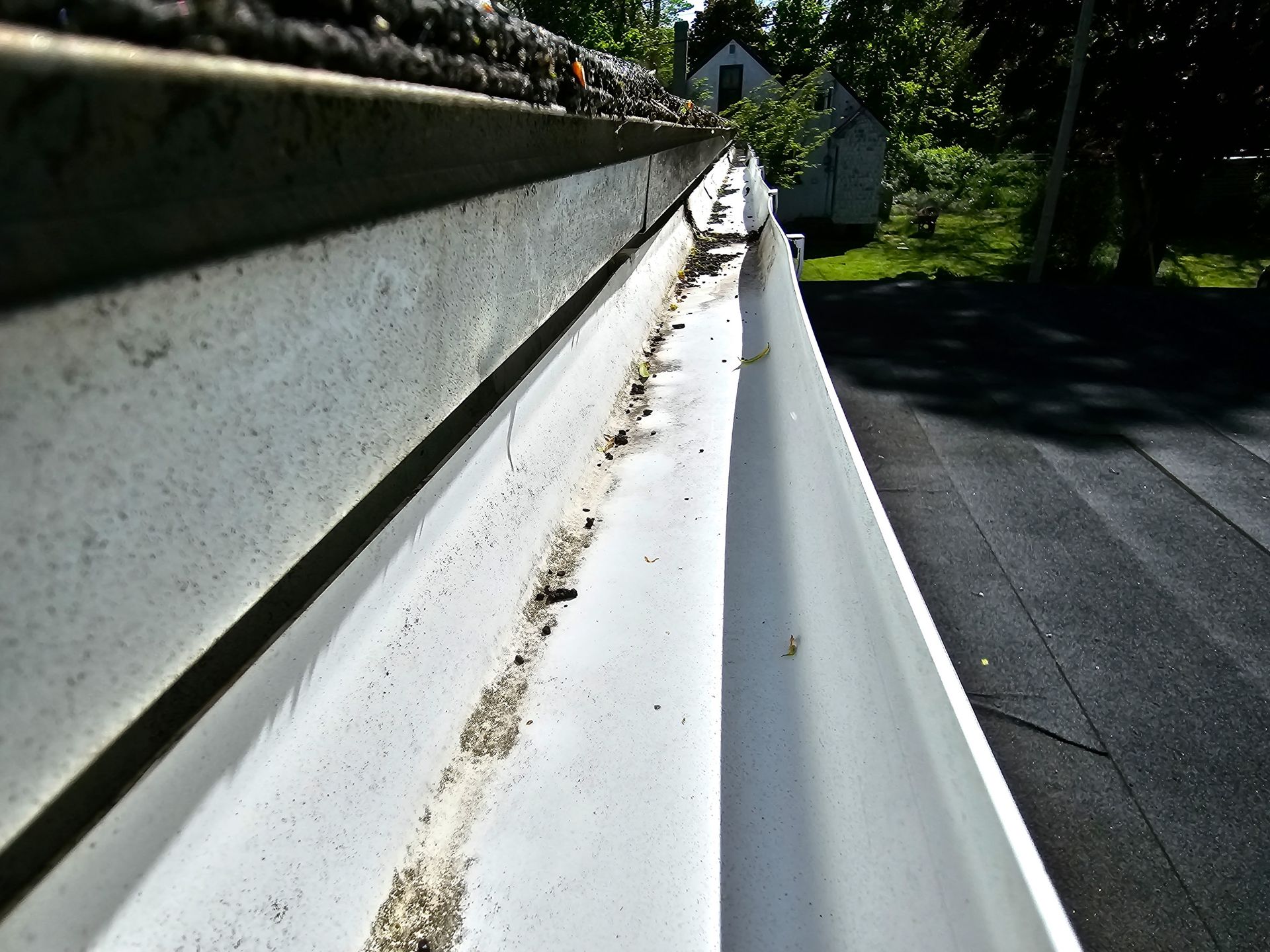 a gutter on the side of a house with a blue sky in the background