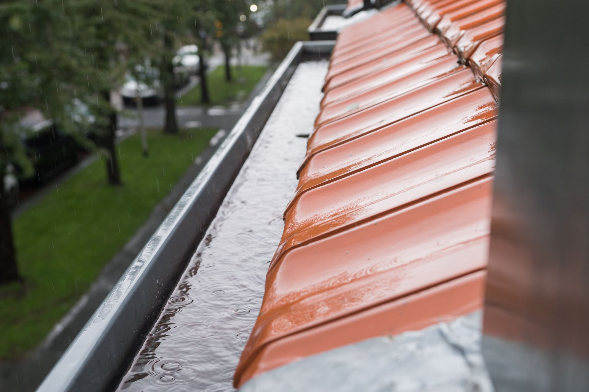 a gutter on the side of a house with a blue sky in the background