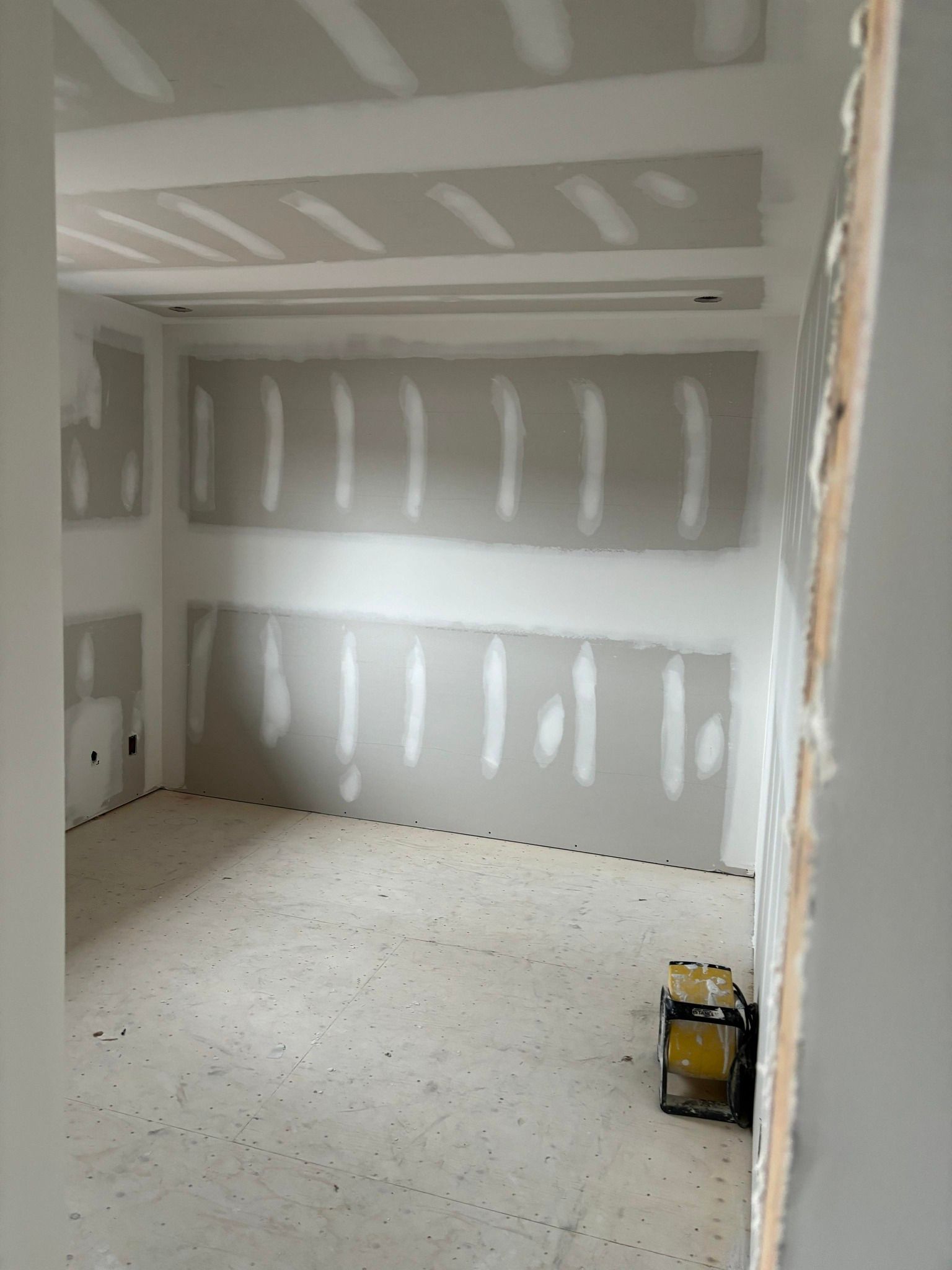 Une pièce avec beaucoup de cloisons sèches sur les murs