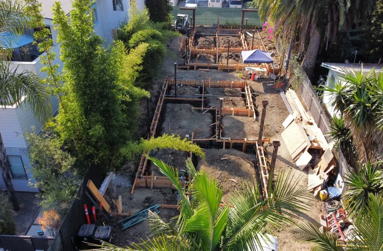 An aerial view of a construction site surrounded by trees.