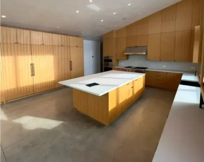 A kitchen with a large island in the middle