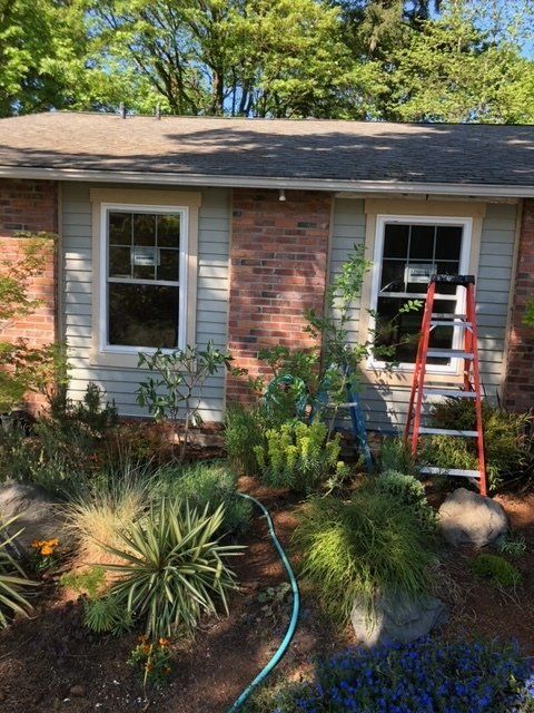 A house with a ladder and a hose in front of it — Tukwila, WA — Bel-Red Windows & Doors