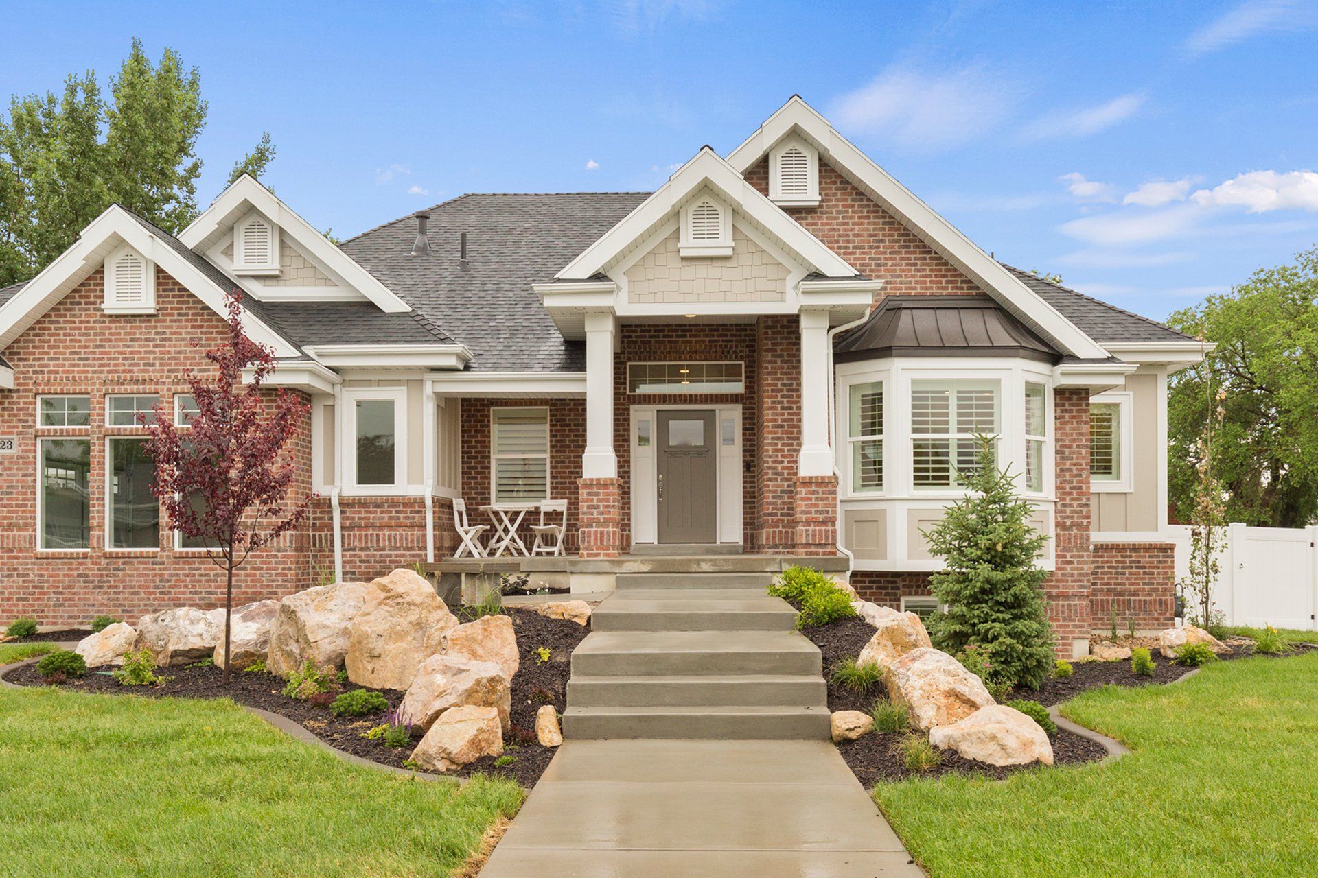 A large brick house with a concrete walkway leading to it. — Tukwila, WA — Bel-Red Windows & Doors