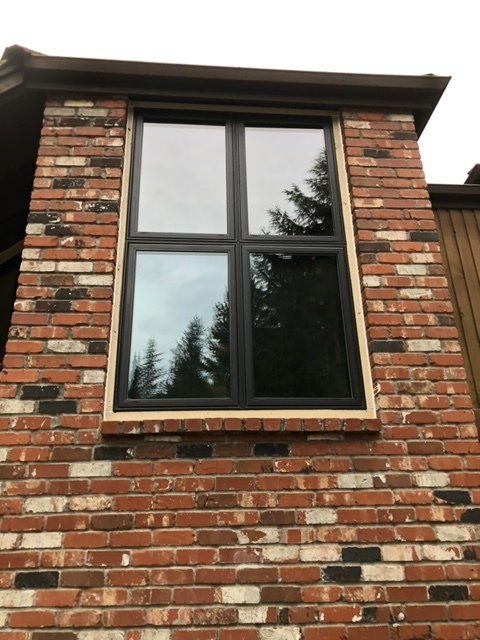 A brick building with a window on the side of it— Tukwila, WA — Bel-Red Windows & Doors