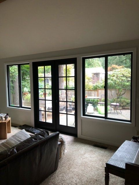 A living room with a couch and sliding glass doors — Tukwila, WA — Bel-Red Windows & Doors