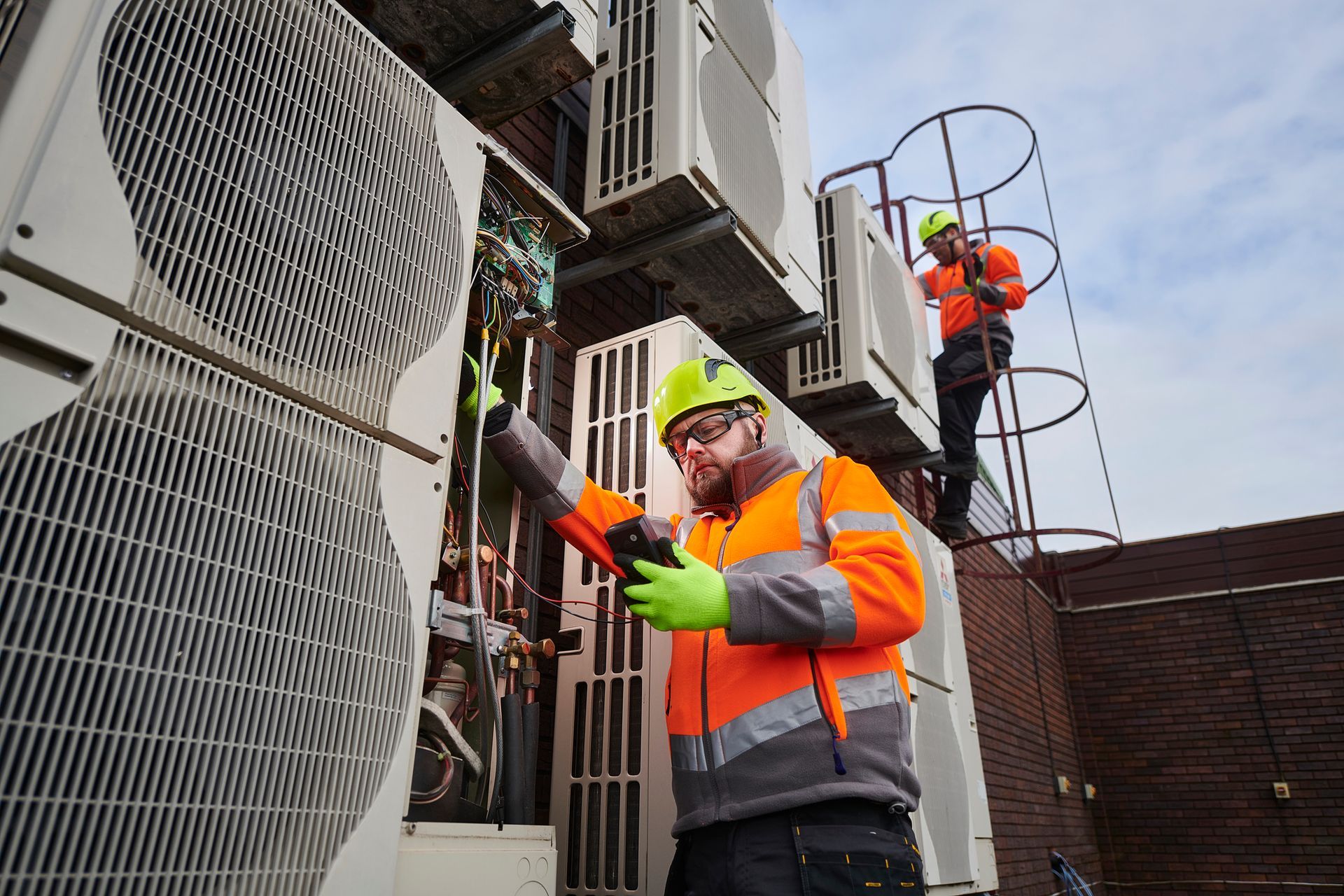 Air-conditioning technicians servicing a commercial property