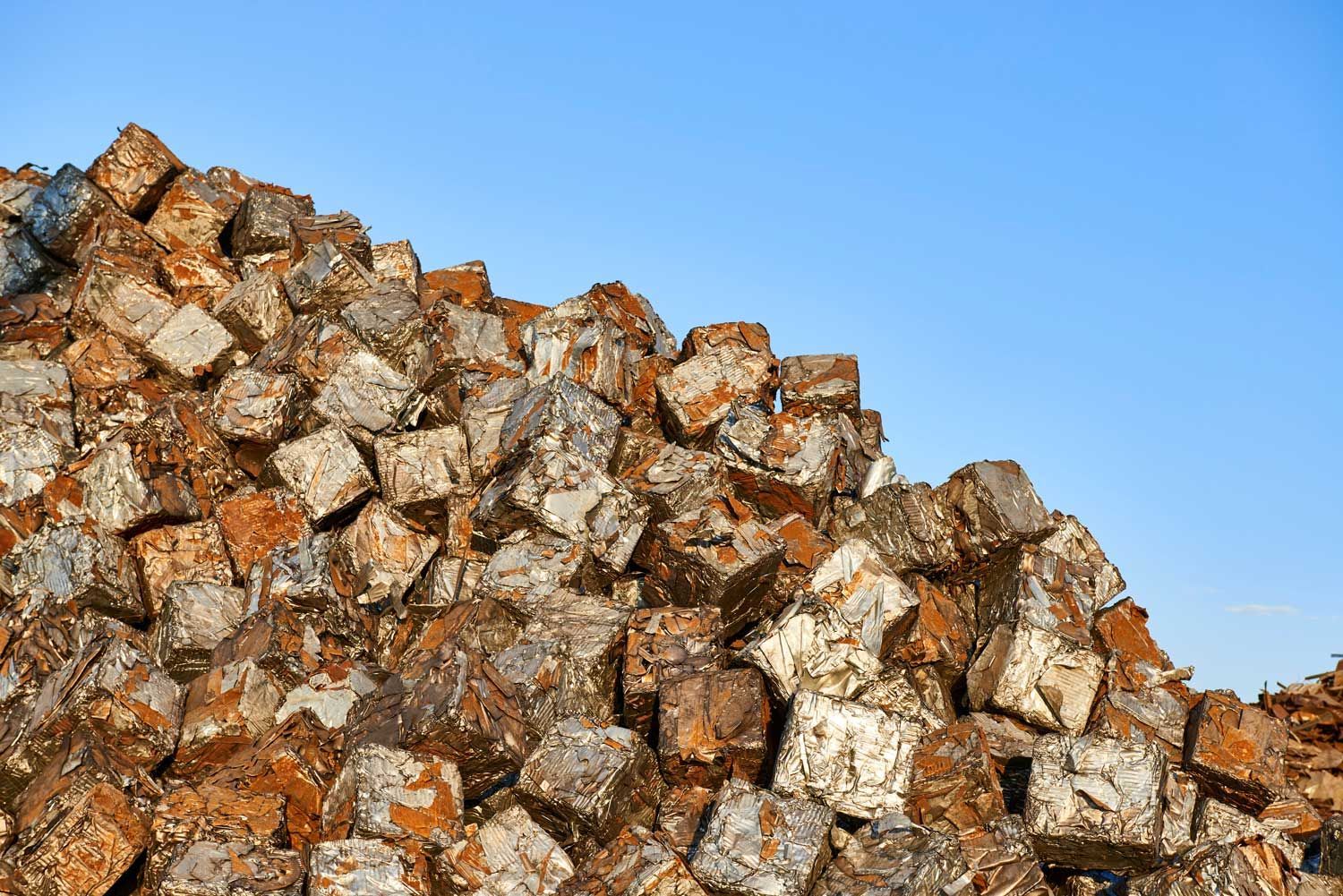 A pile of scrap metal outdoors.