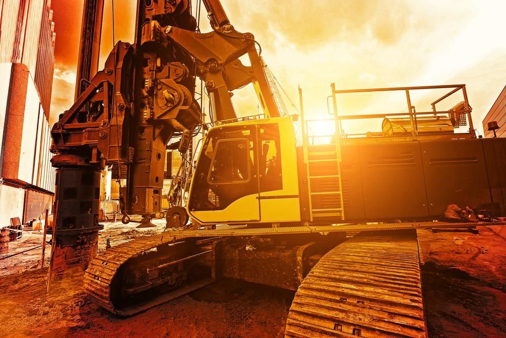 Large Yellow Excavator is Working on a Construction Site at Sunset — Hannant Plant Hire in Robina, QLD