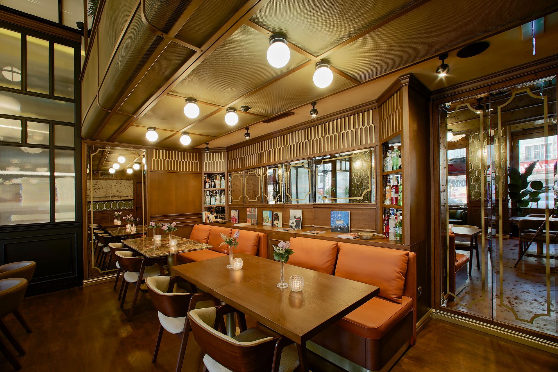 A restaurant with tables and chairs and a couch.