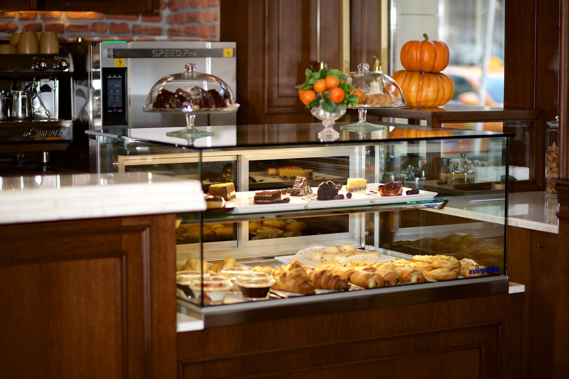 A bakery with a glass display case filled with pastries.