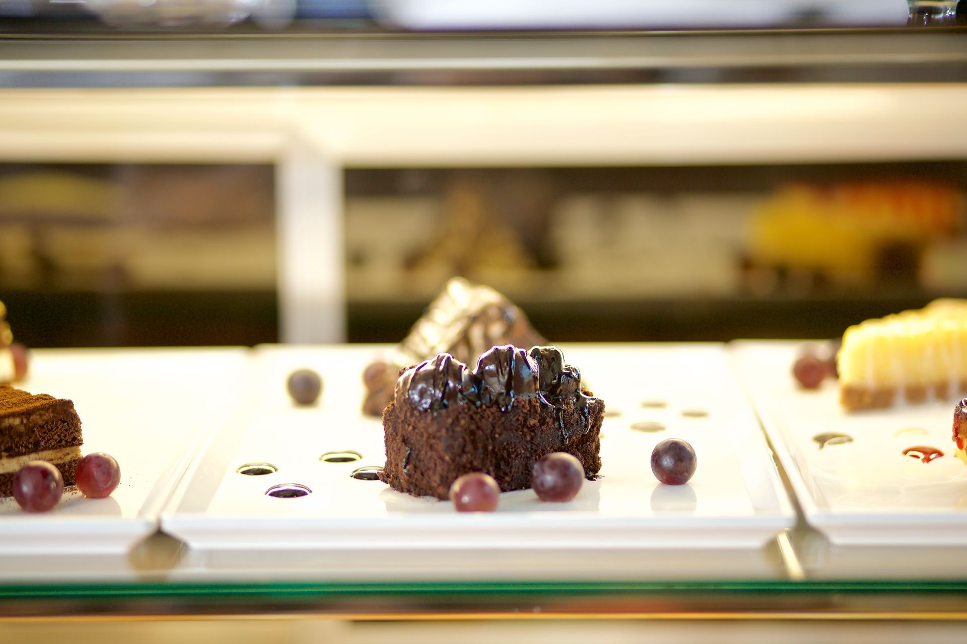 A close up of a dessert on a plate in a display case.