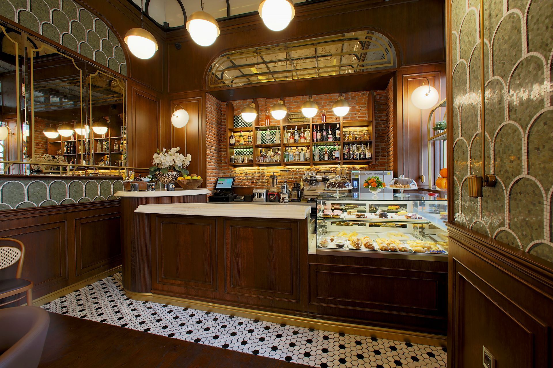A restaurant with a counter and a display case filled with food.