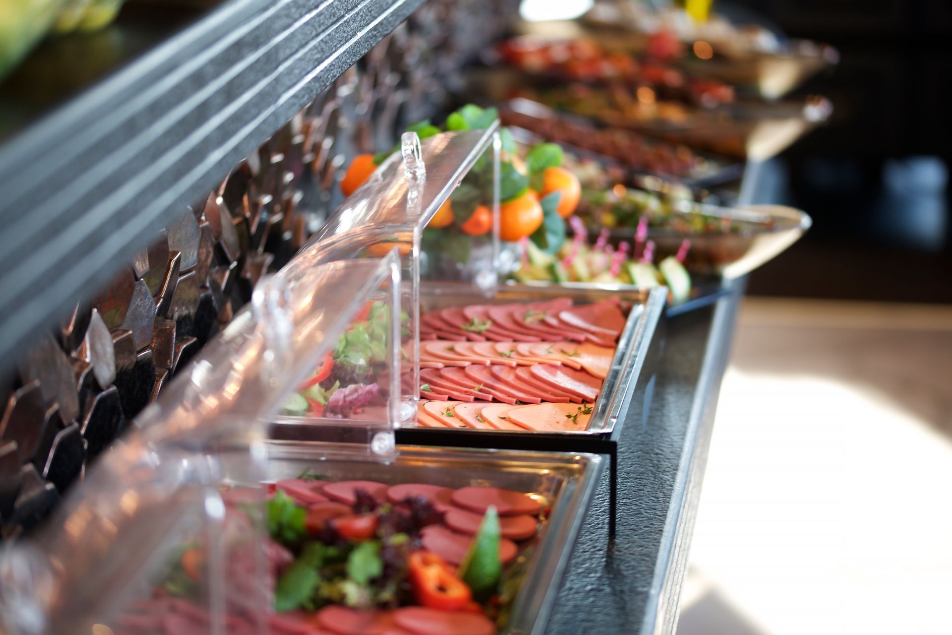 A buffet table with a variety of food on it.