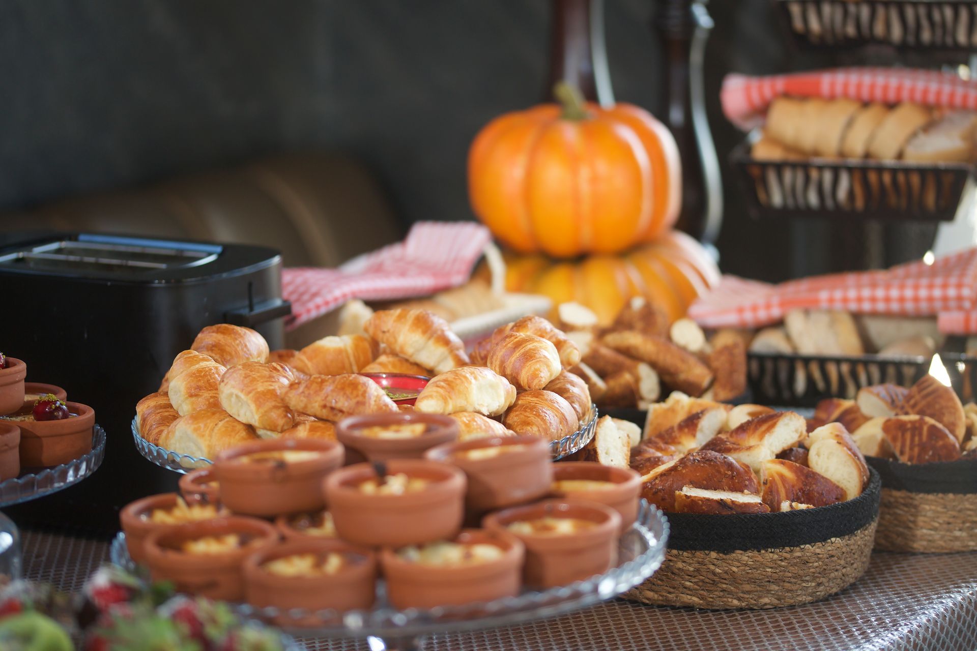 A table topped with a variety of food and a pumpkin.