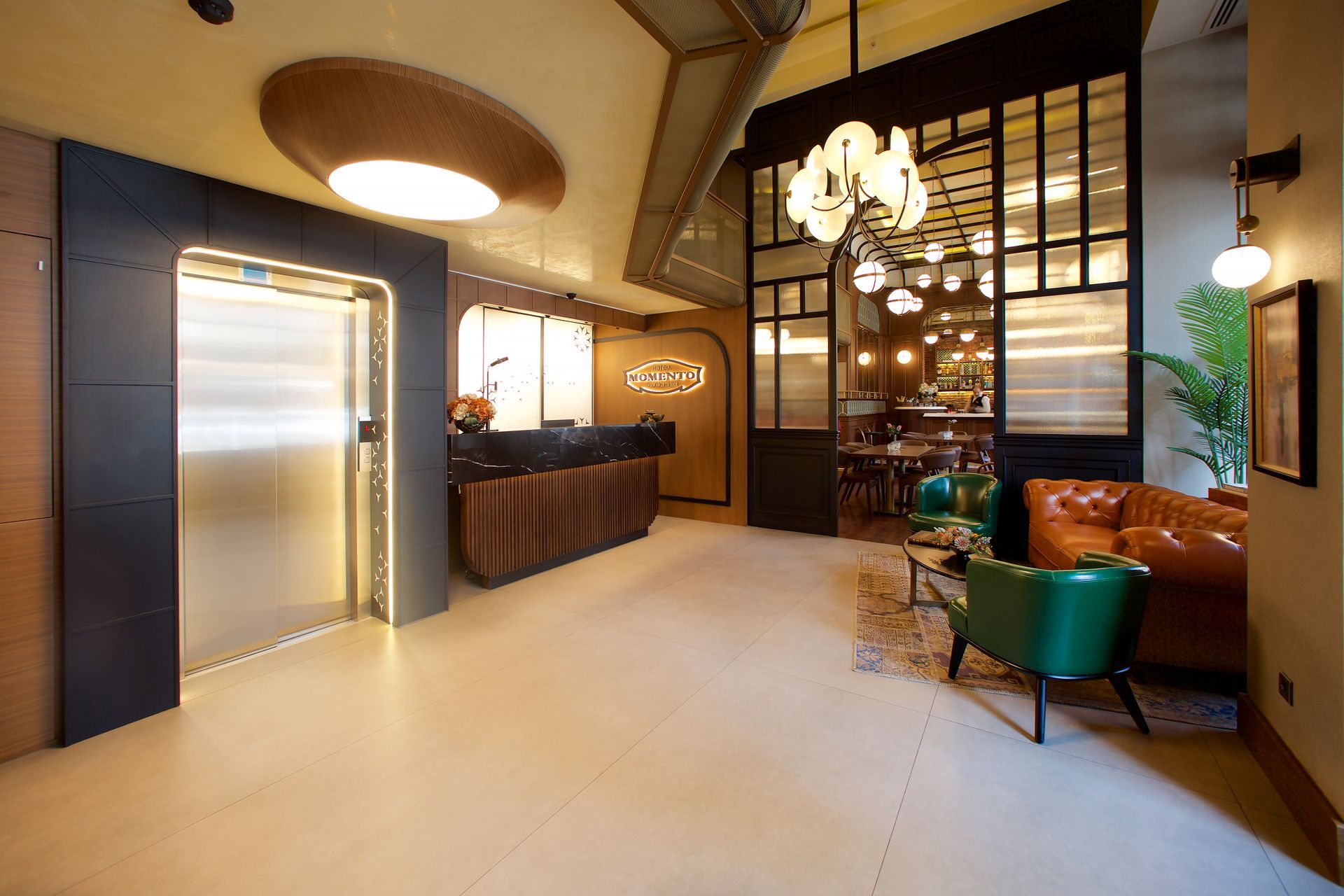 A lobby with a reception desk , chairs , a couch and an elevator, momento hotels beyazıt images