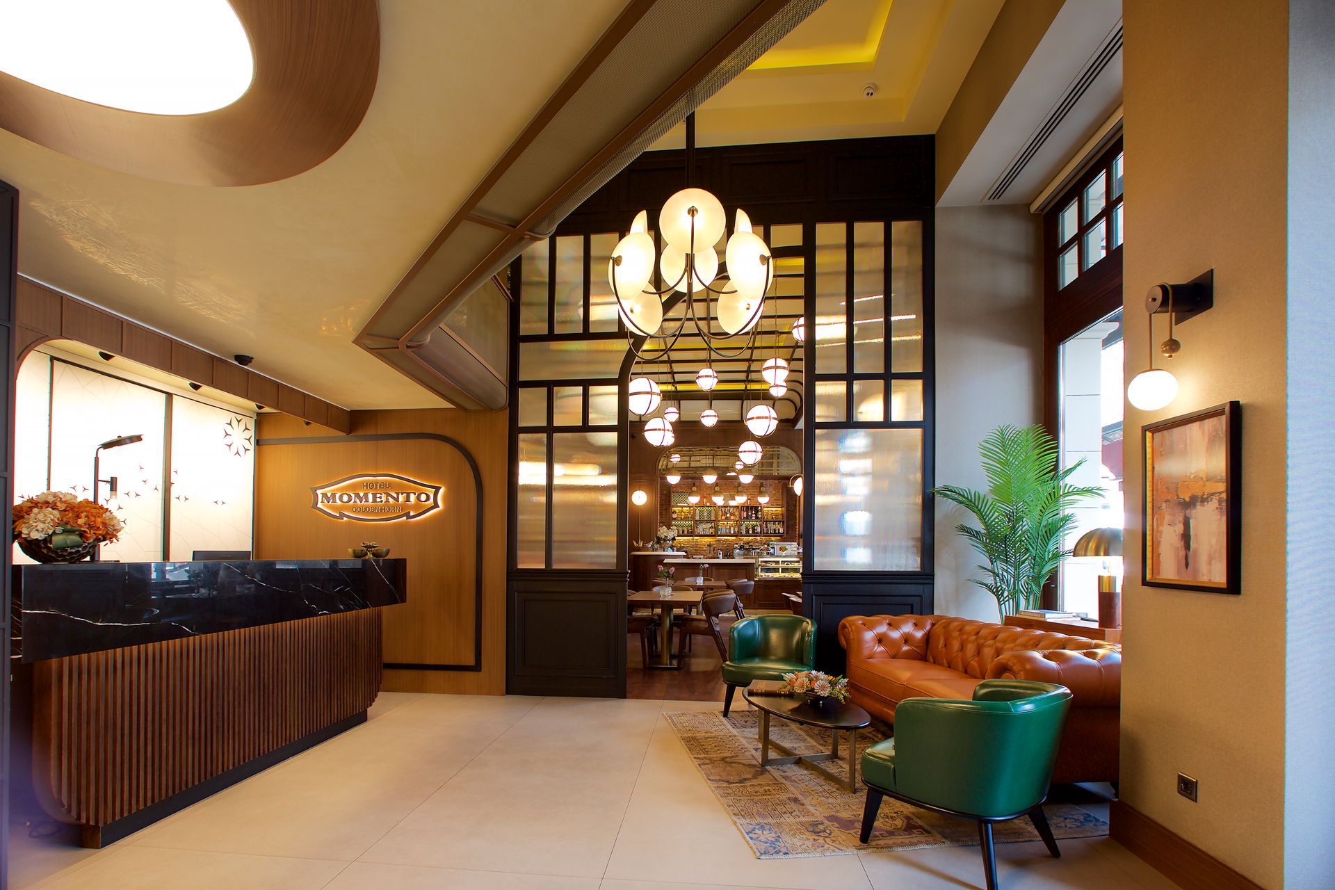 A lobby of a hotel with a couch and chairs, momento hotels beyazıt