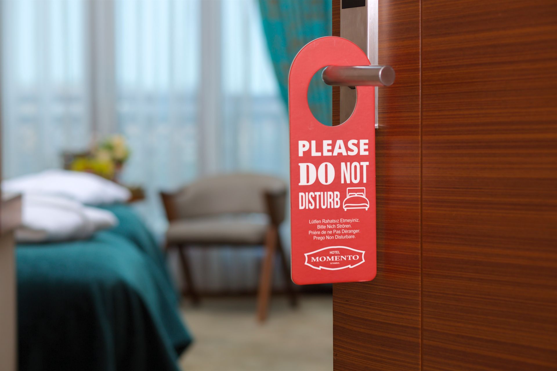 A red do not disturb sign hangs on a hotel door