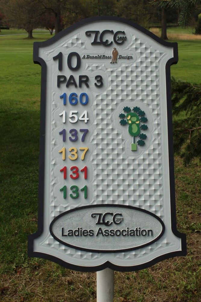 A sign on a golf course that says tcg ladies association