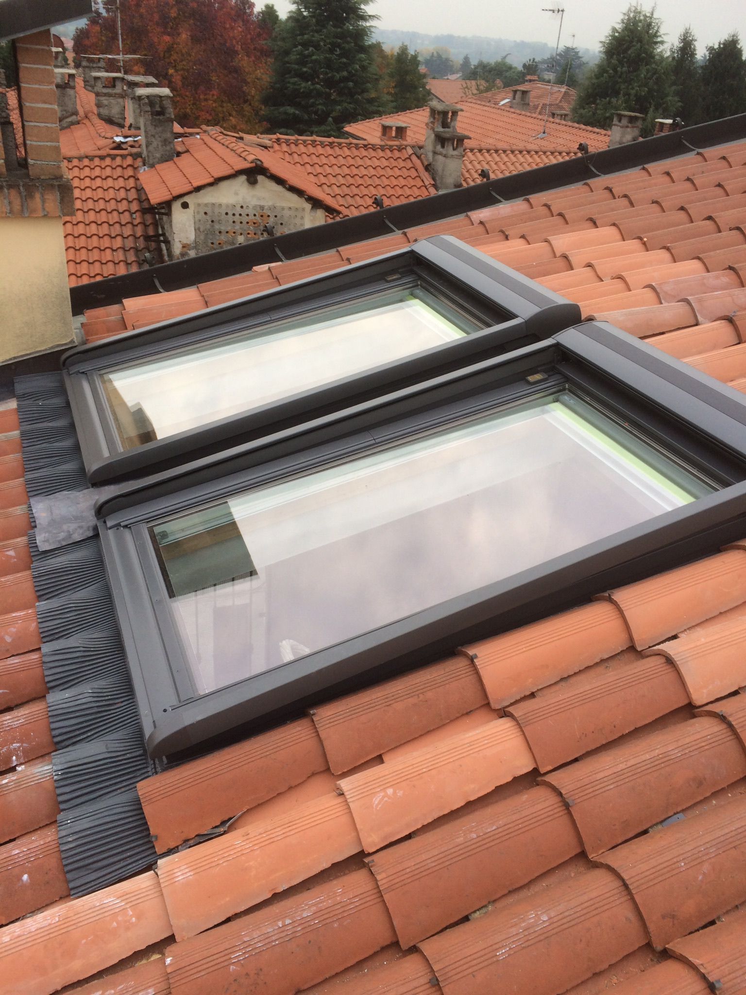 Due lucernari rettangolari su un tetto di tegole rosse. 
