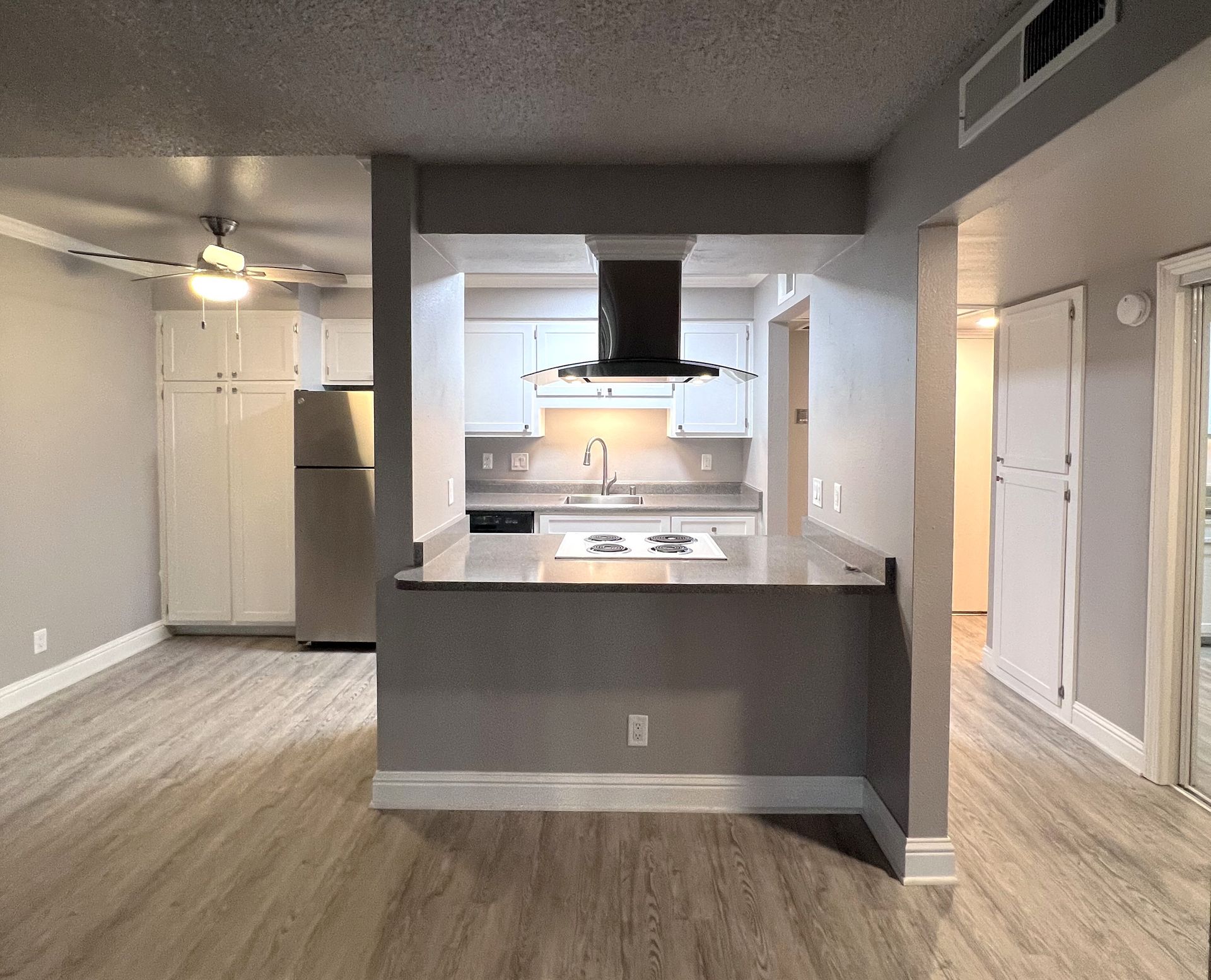 a kitchen with a stove top oven and a refrigerator