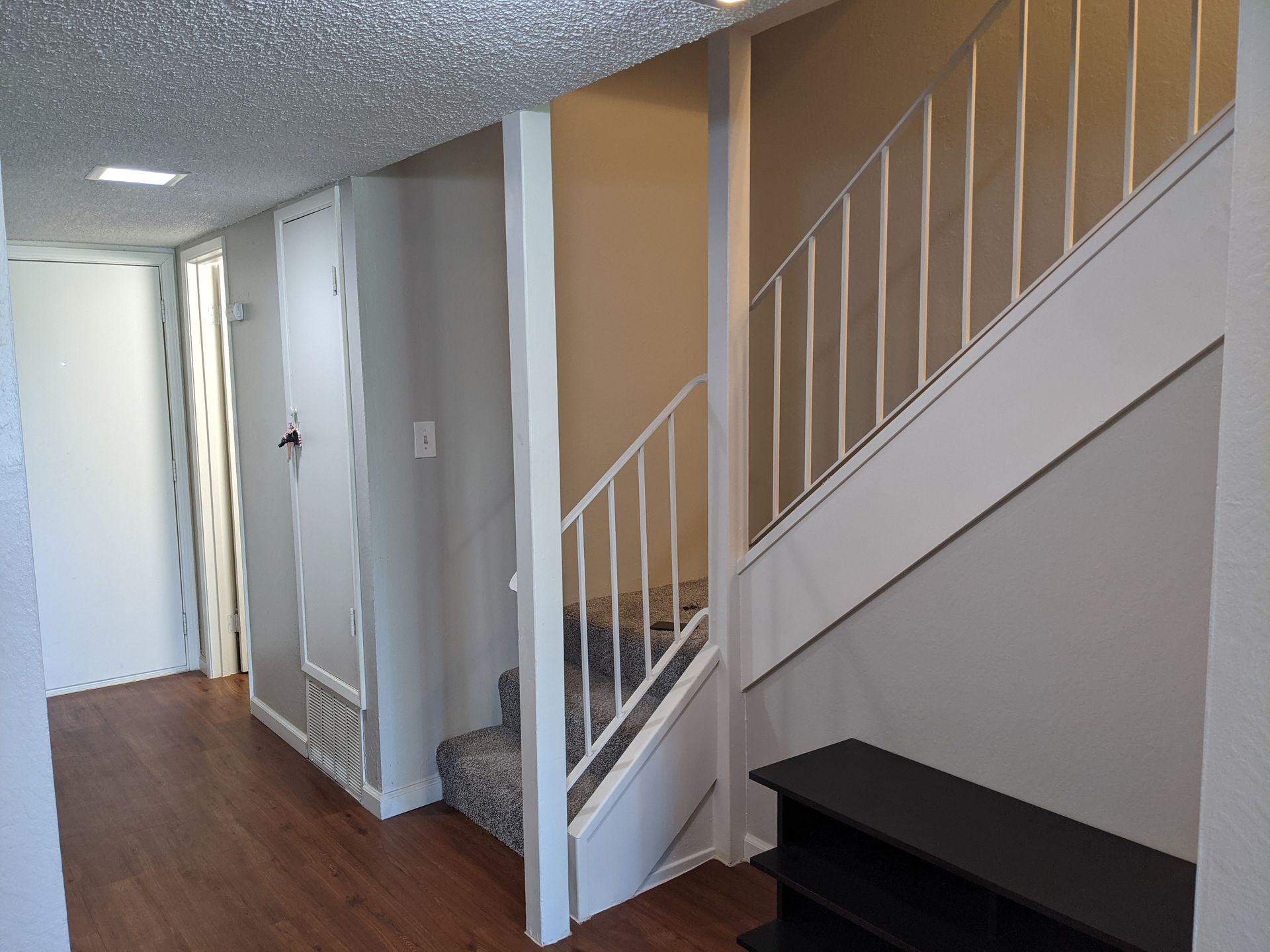 a hallway with stairs leading up to the second floor