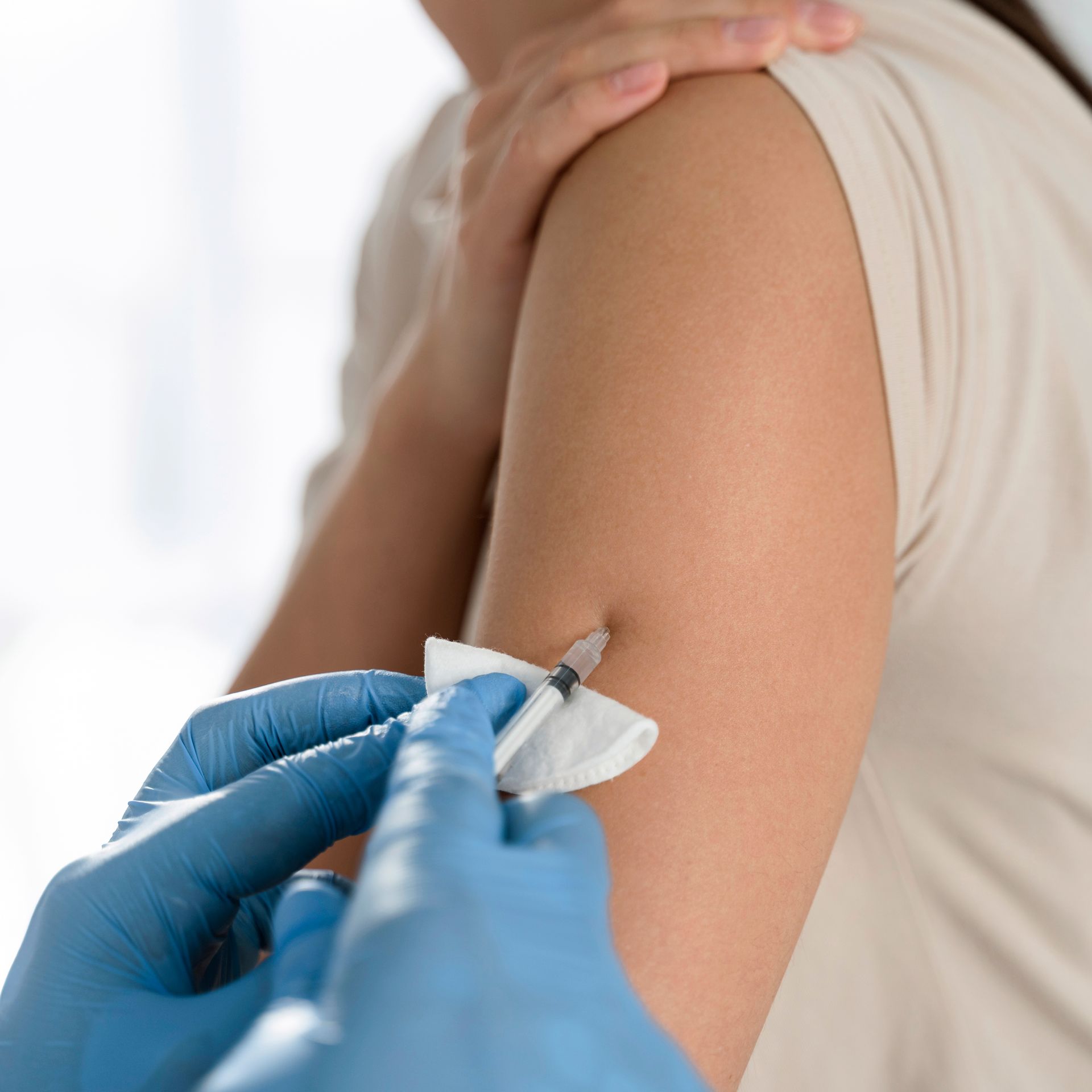 a woman is getting an injection in her arm