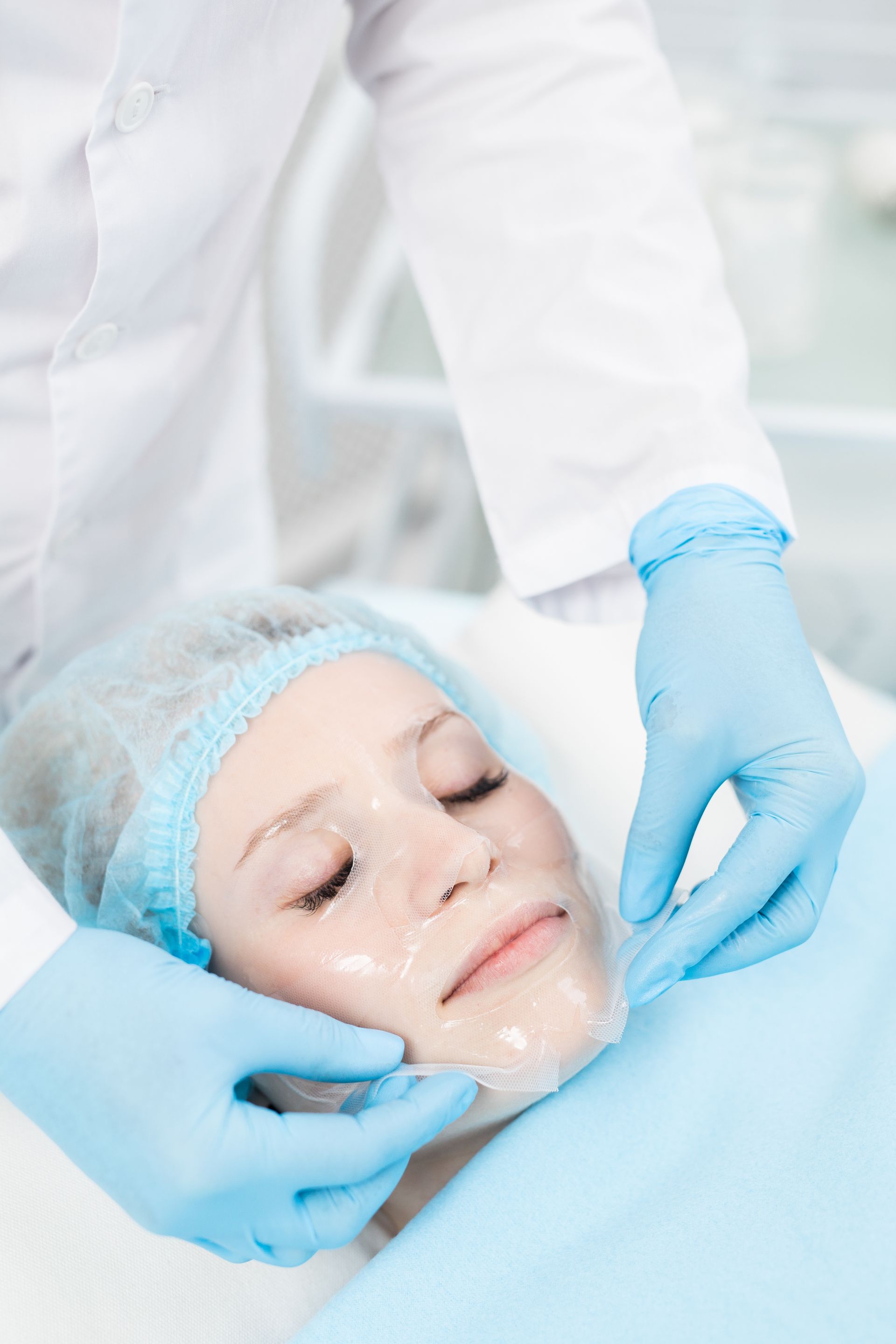 A woman is getting a facial treatment at a beauty salon.