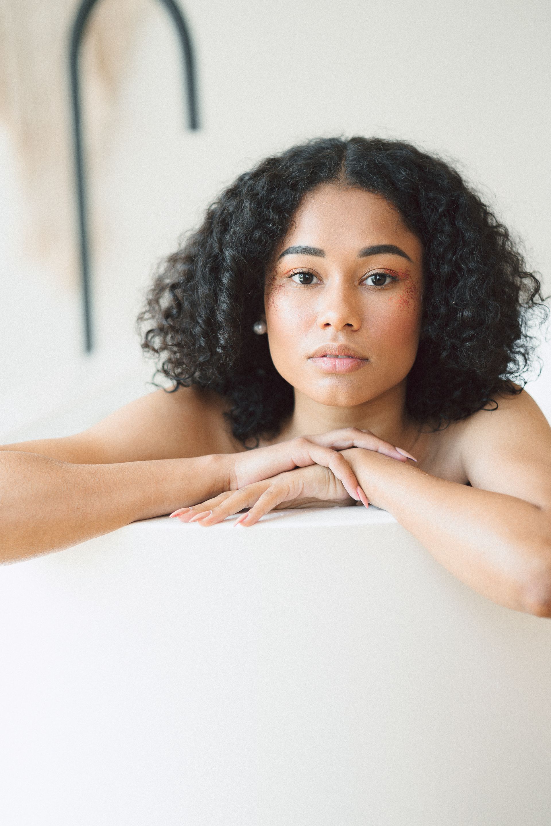 a woman is sitting in a bathtub with her head resting on the edge .