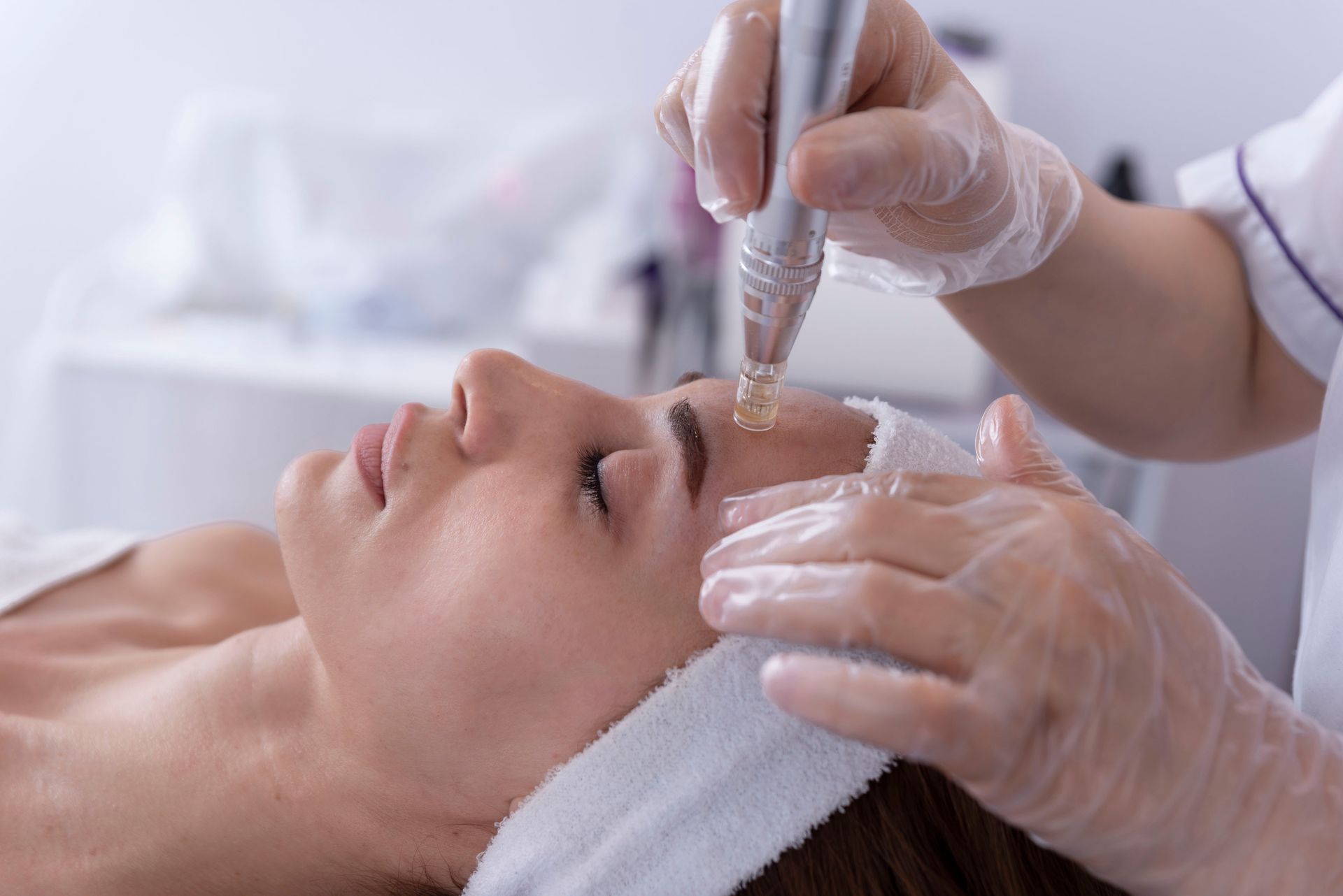 a woman is getting a facial treatment at a beauty salon .