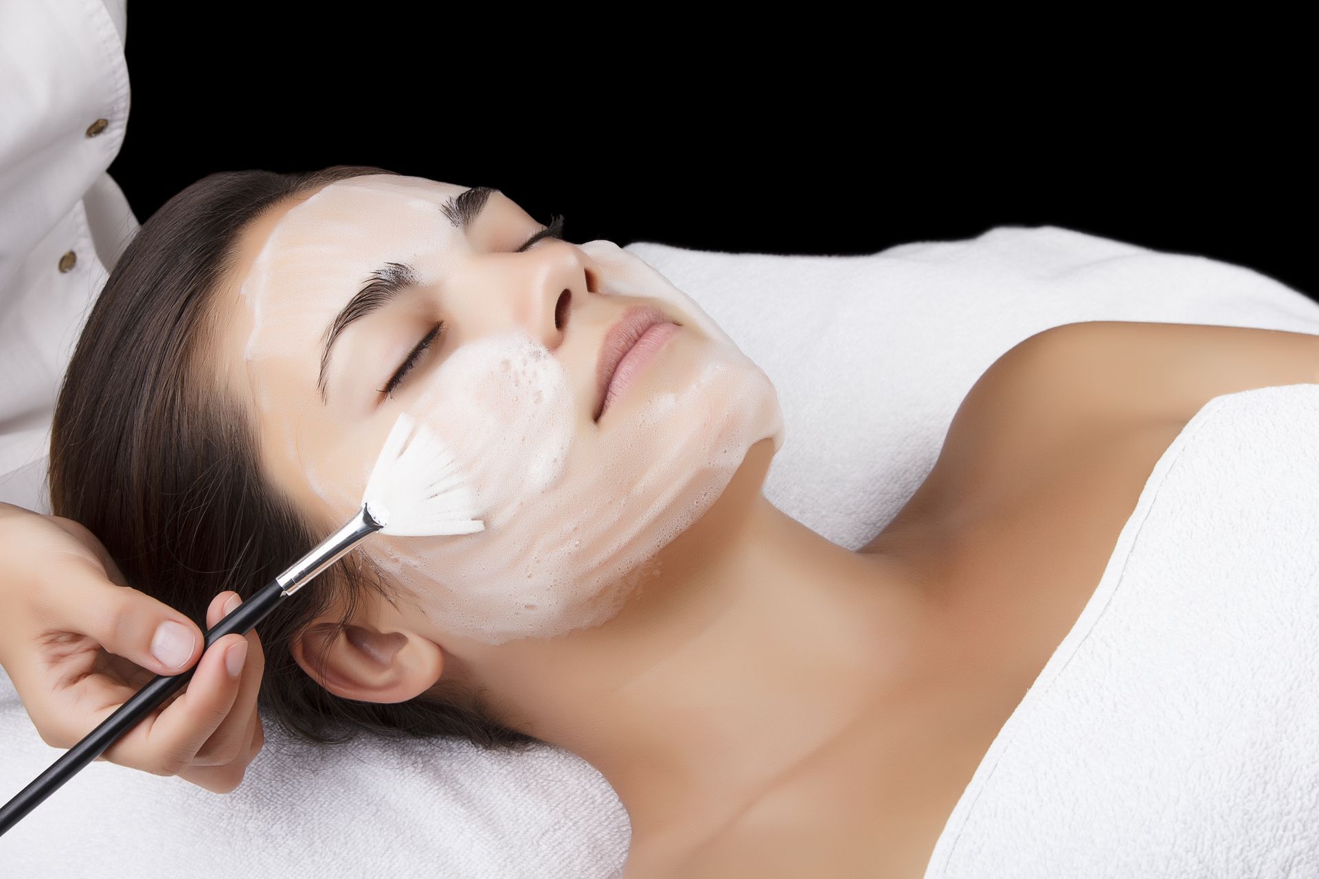 A woman is getting a facial treatment at a spa.