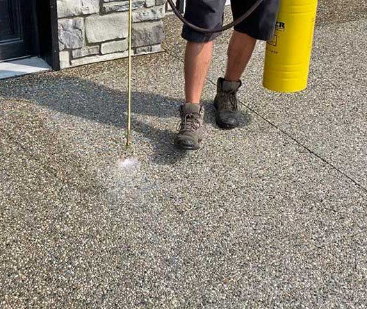 CONCRETE SEALING: Concrete sealer job in progress.