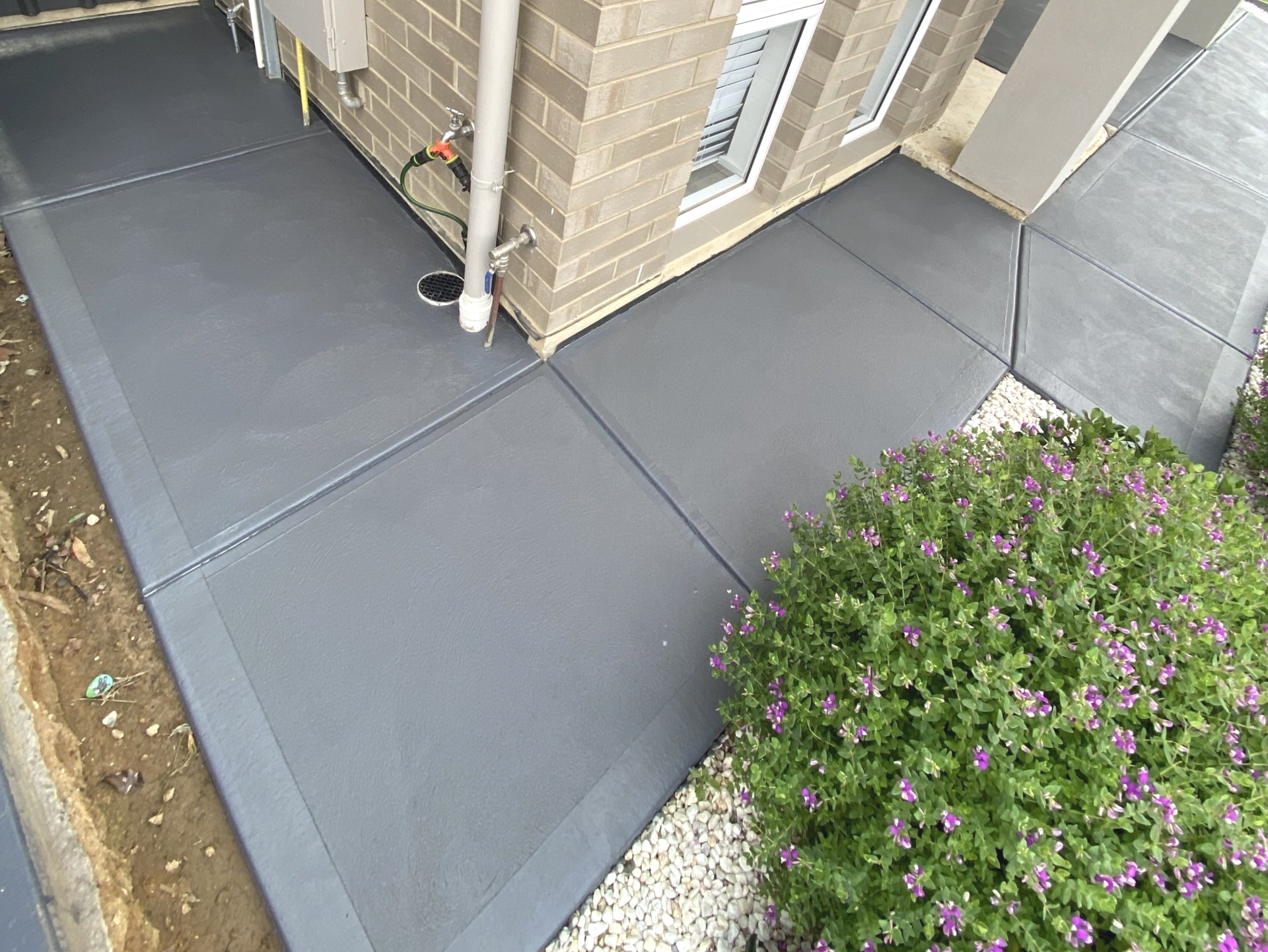 CONCRETE SEALING: Concrete sealing a residential pathway in grey.